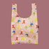 A neutral nylon tote bag with a multi colored bear graphic. 