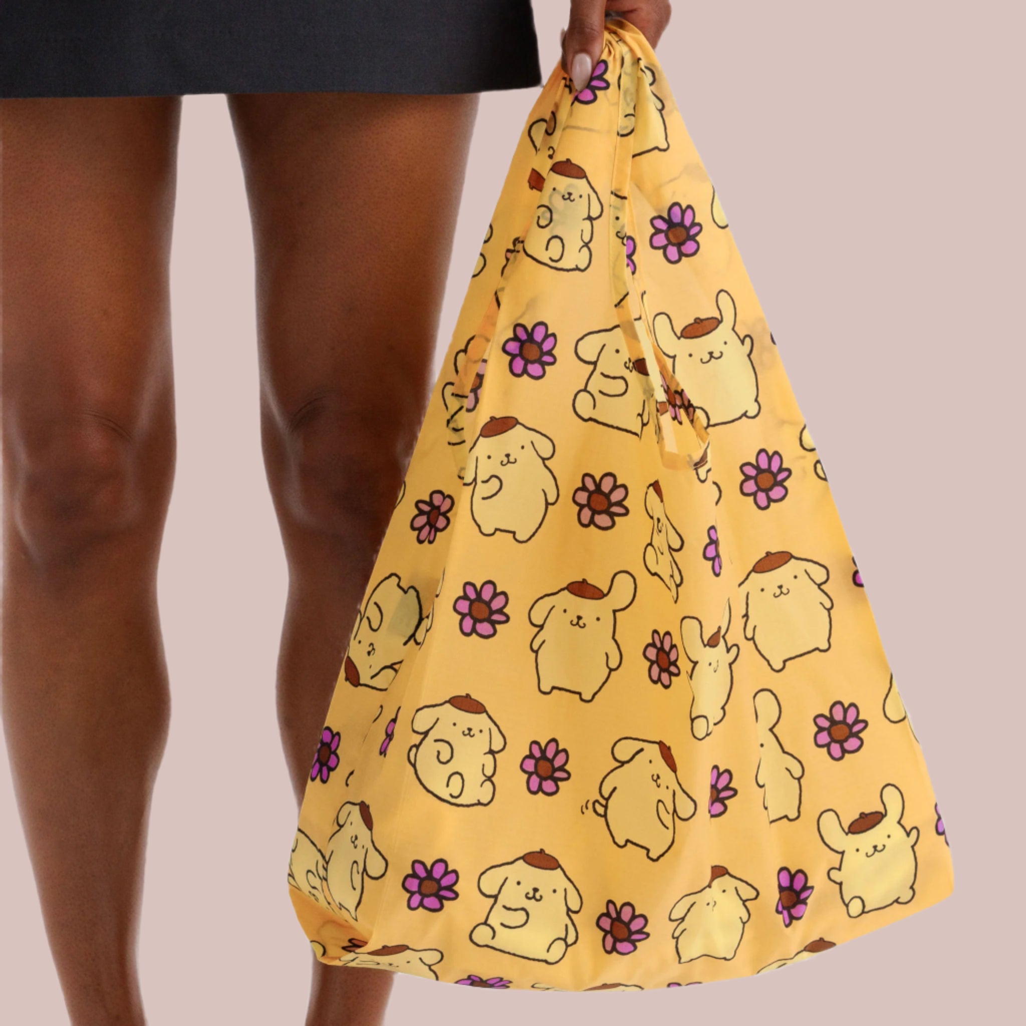 A yellow nylon tote bag with a Pompompurin pattern. 