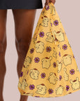 A yellow nylon tote bag with a Pompompurin pattern. 