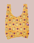 A yellow nylon tote bag with a Pompompurin pattern. 