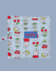 A light blue nylon bag with a cherry, flower and Miffy pattern. 