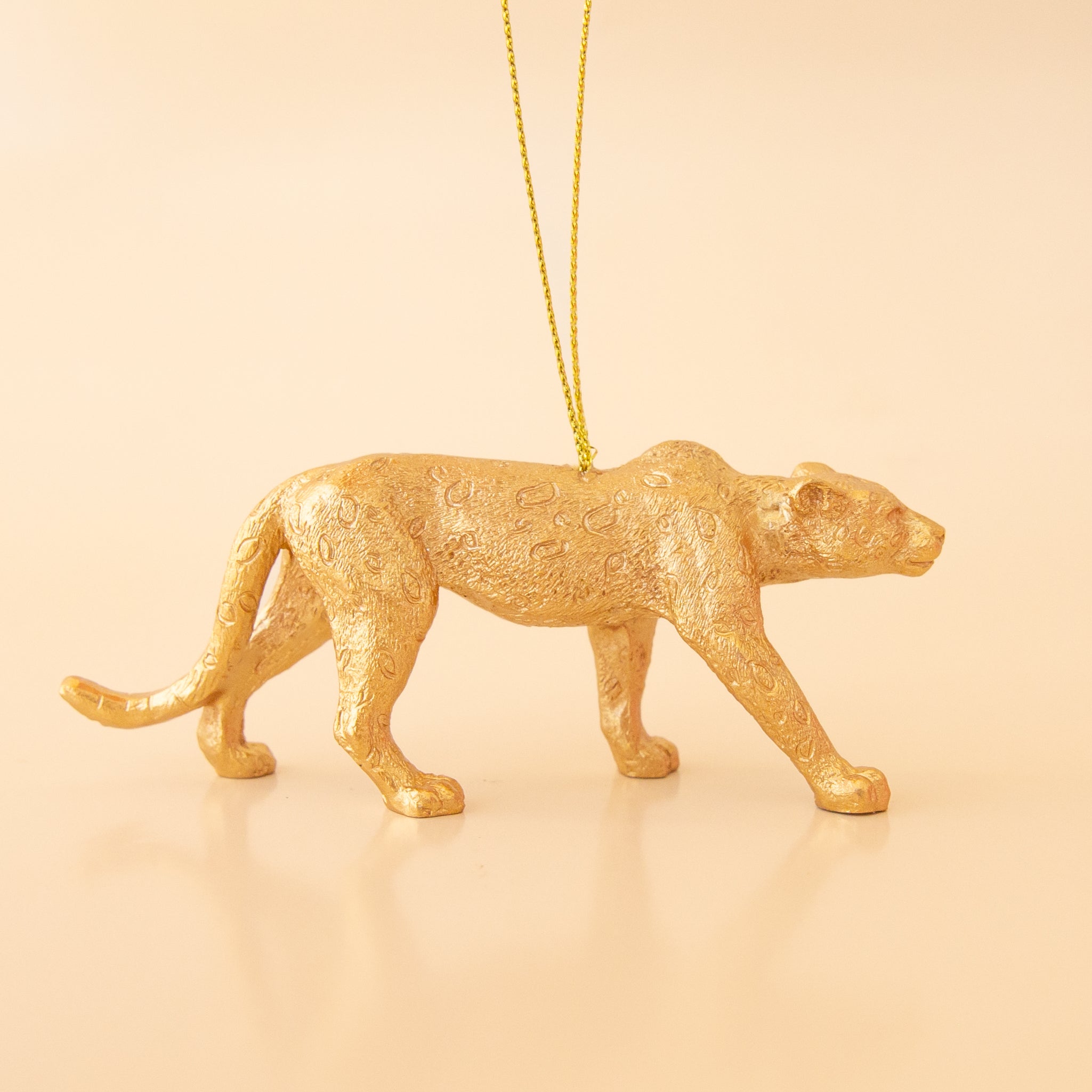 Gold wild cat ornament. The cat is standing. 