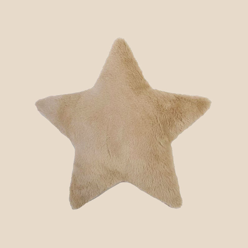 A tan star shaped fuzzy pillow. 
