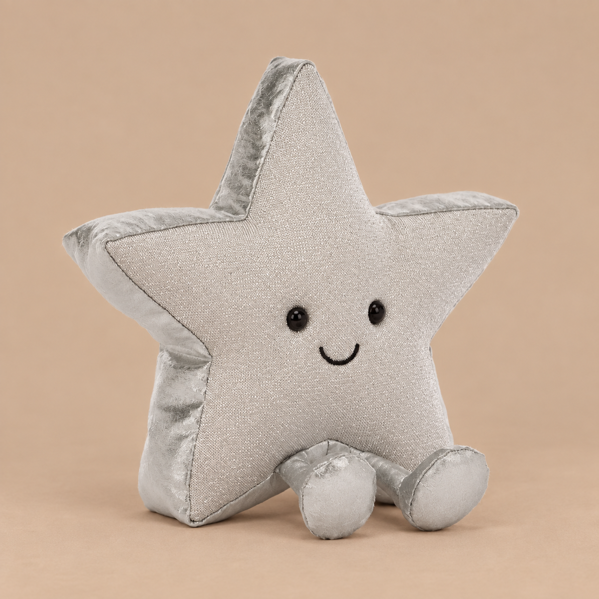 a silver star shaped plush toy. 