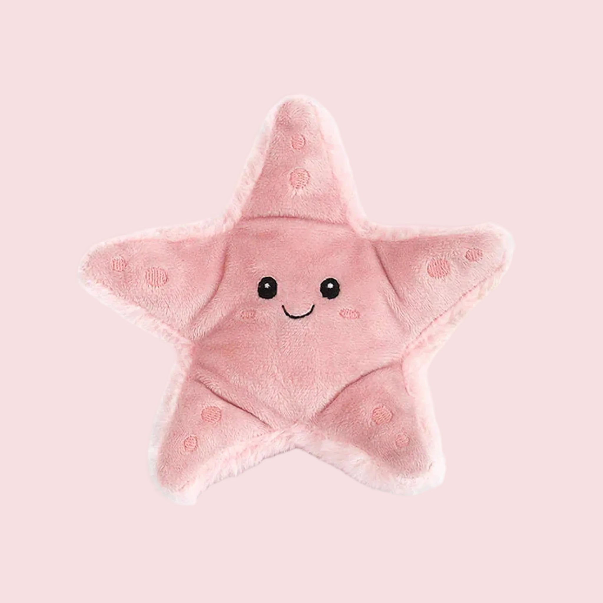 A light pink starfish shaped stuffed toy with a smiling face. 