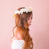 A flower crown made up of neutral dried florals and a tie detail at the back. 