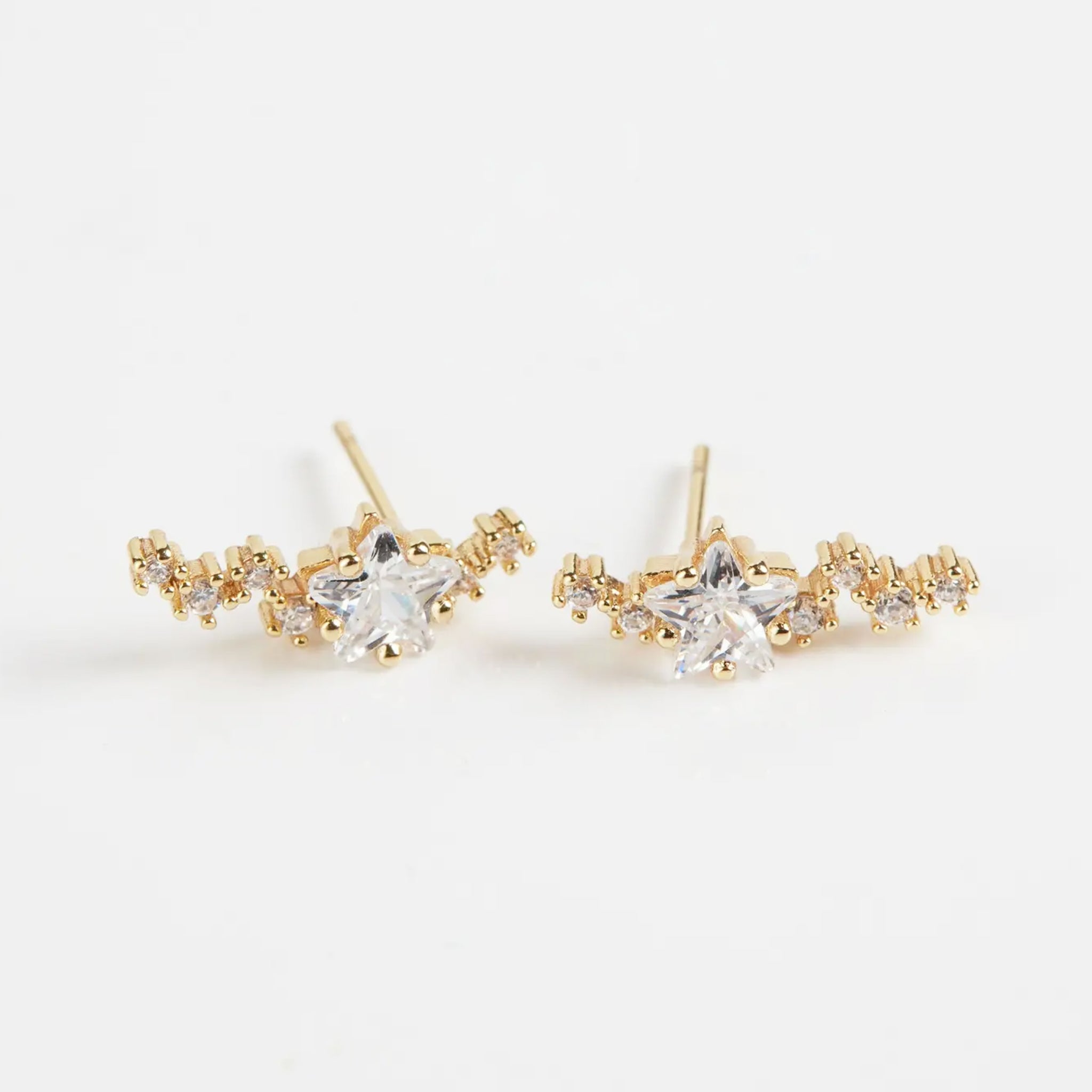 A gold pair of crawler earrings with star shaped stones. 