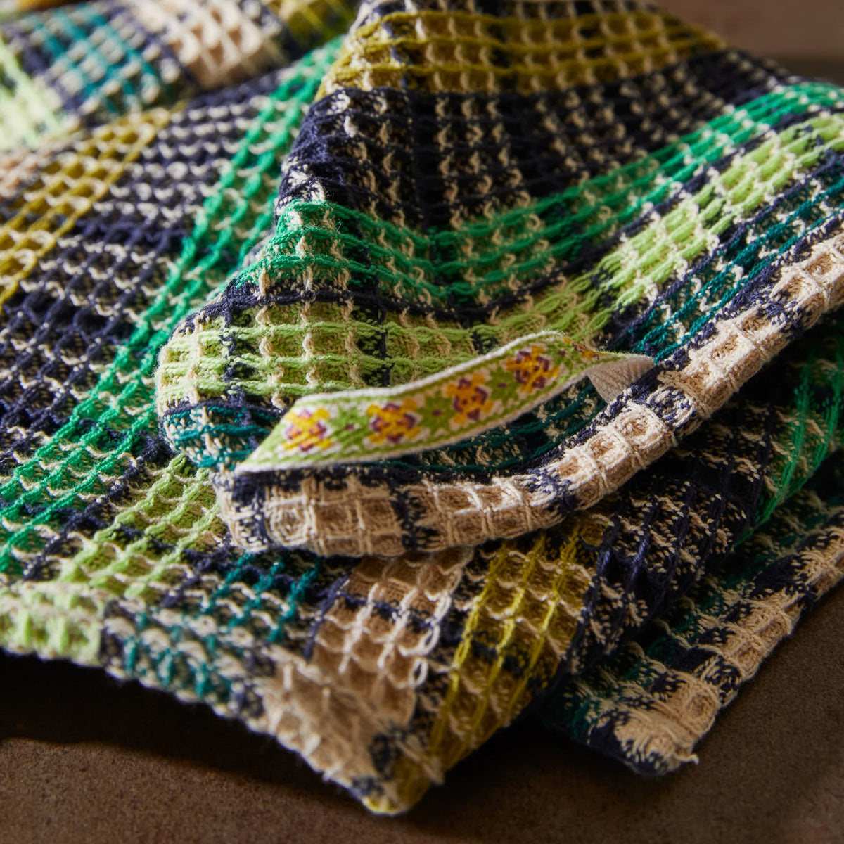 A green check waffle knit tea towel. 