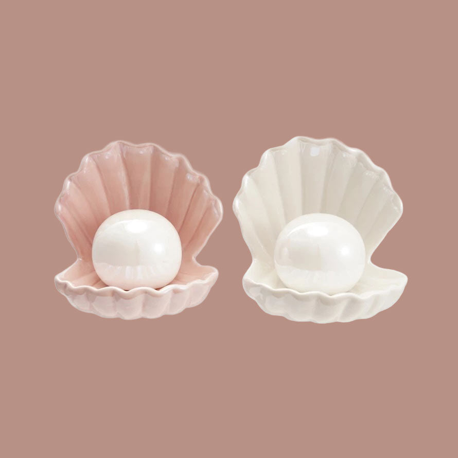 A clam seashell shaped lamp with a round light in the center. 