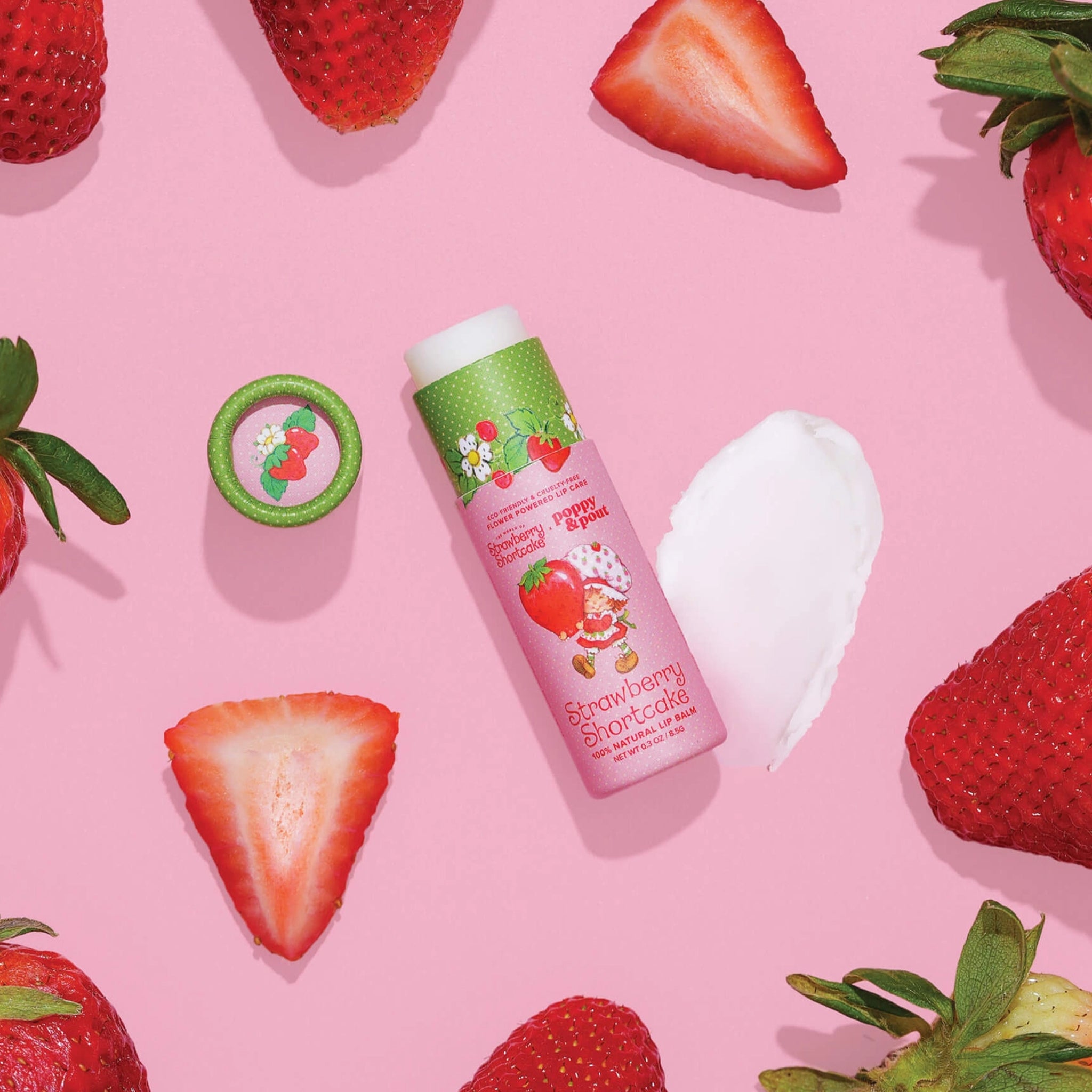 A pink and green tube of lip balm with text that reads, 'Strawberry Shortcake'. 