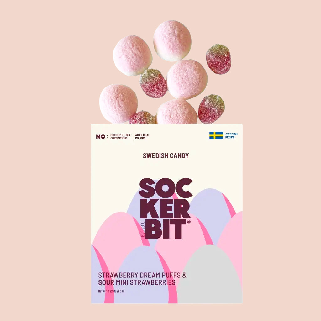 Box of Sockerbit Swedish candy labeled ‘Strawberry Dream Puffs & Sour Mini Strawberries’ with pink candies floating above the package on a pastel background.