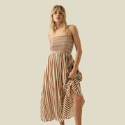 A brown and tan striped smoked dress with thin spaghetti strap. 
