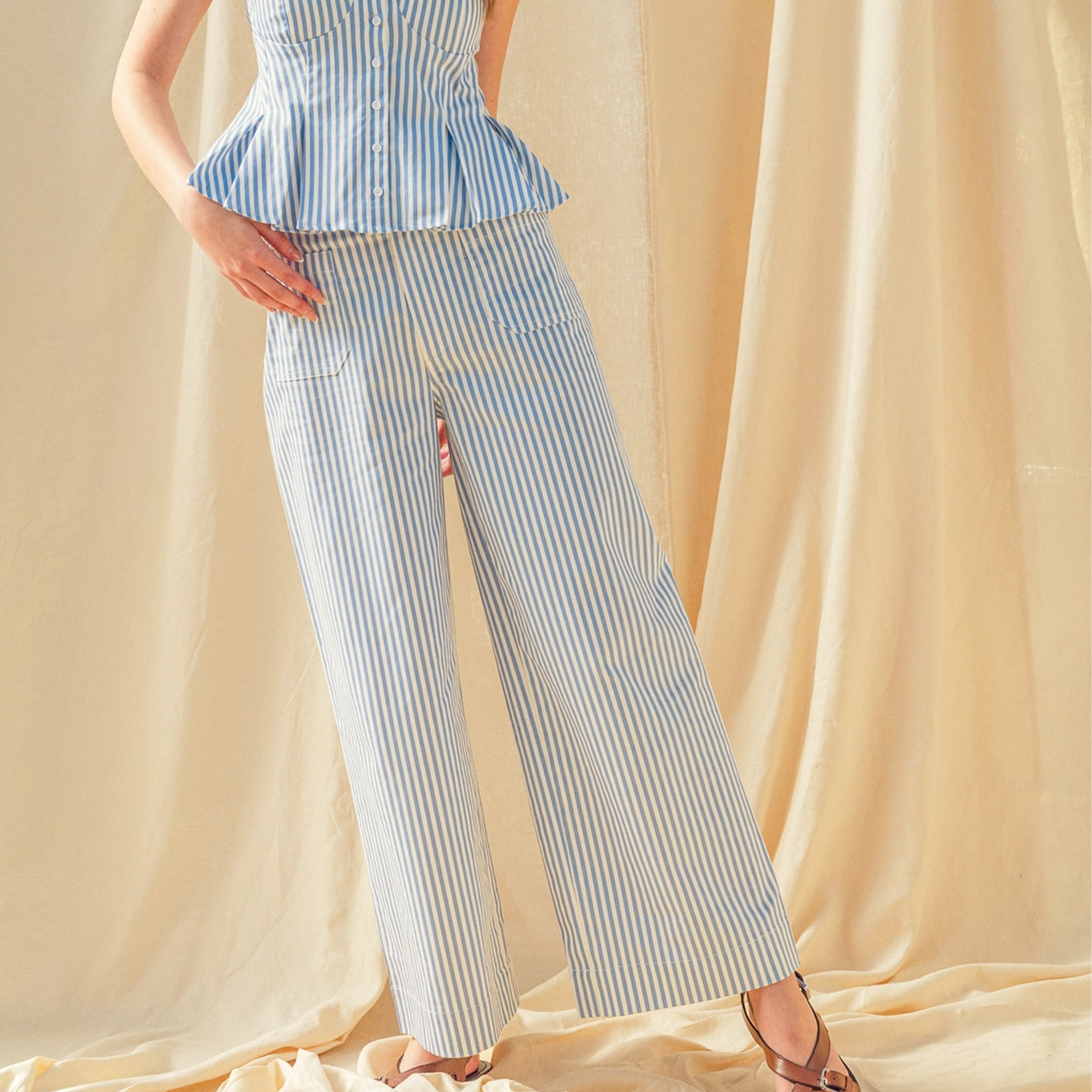 A blue and white striped stretch straight leg pant with front pockets.