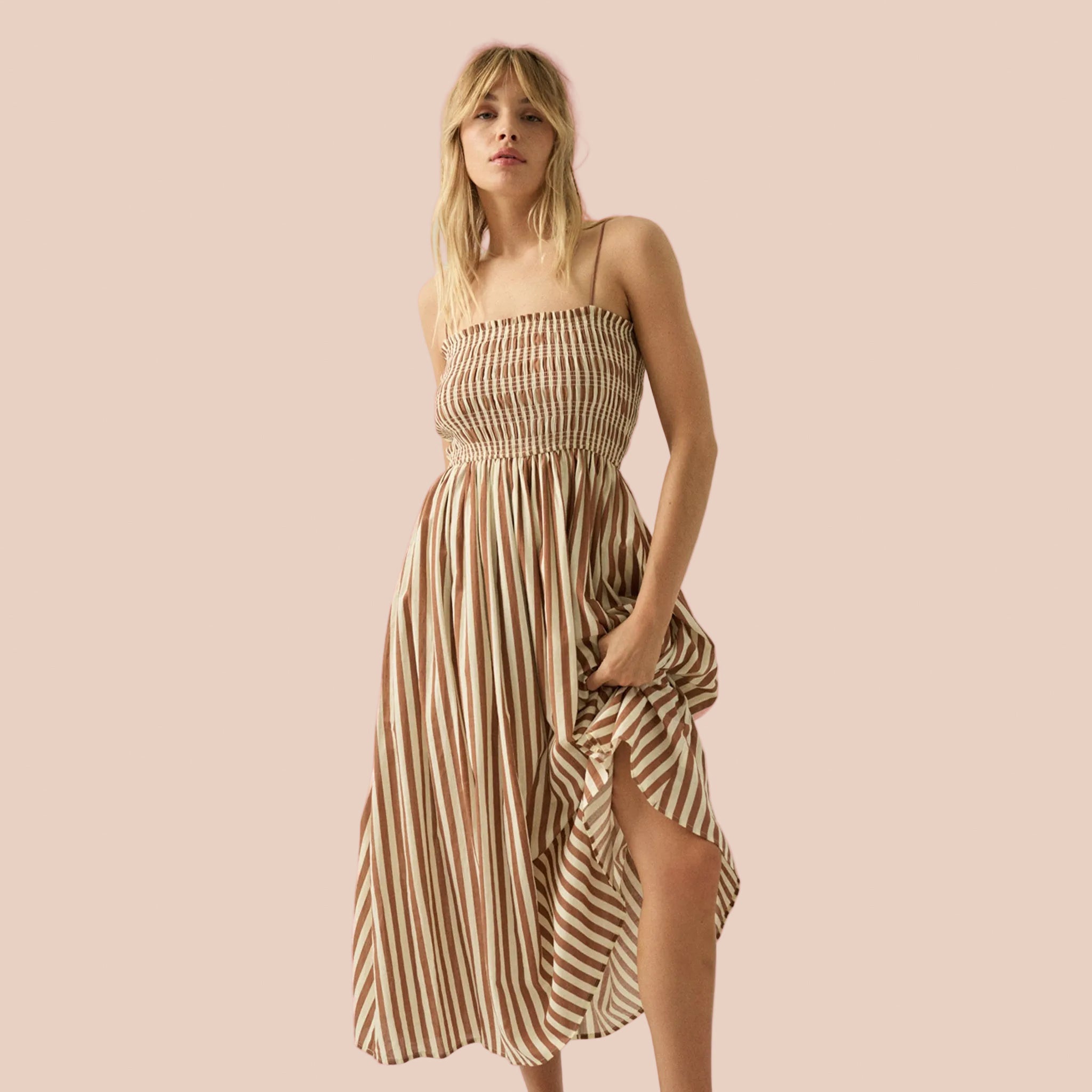A brown and tan striped smoked dress with thin spaghetti strap. 