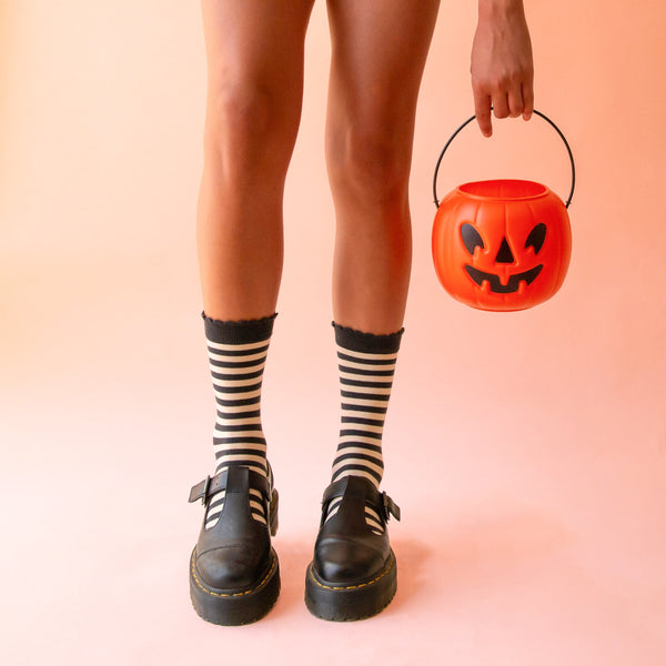 A pair of black and cream striped crew socks. 