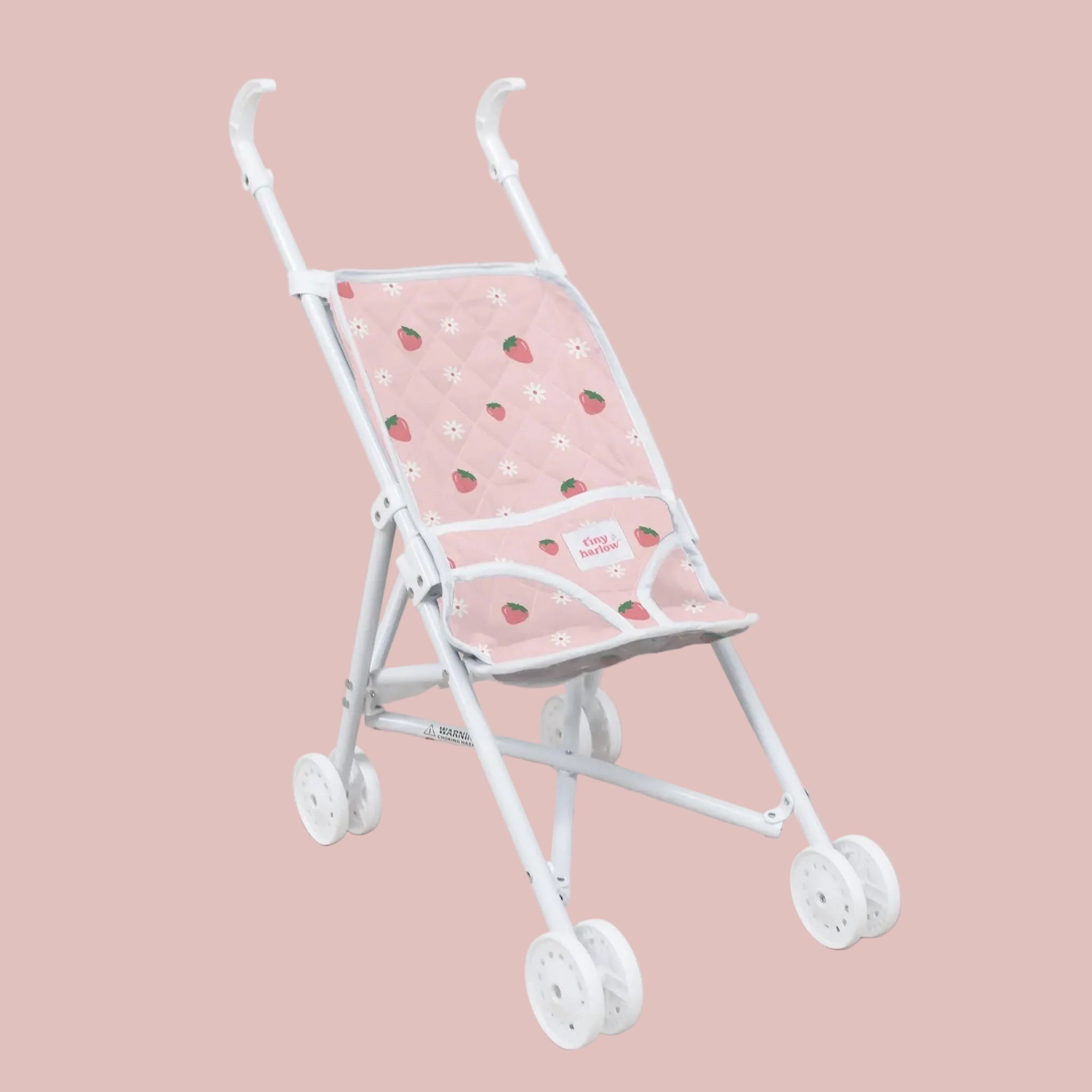 A pink doll stroller with a strawberry print. 