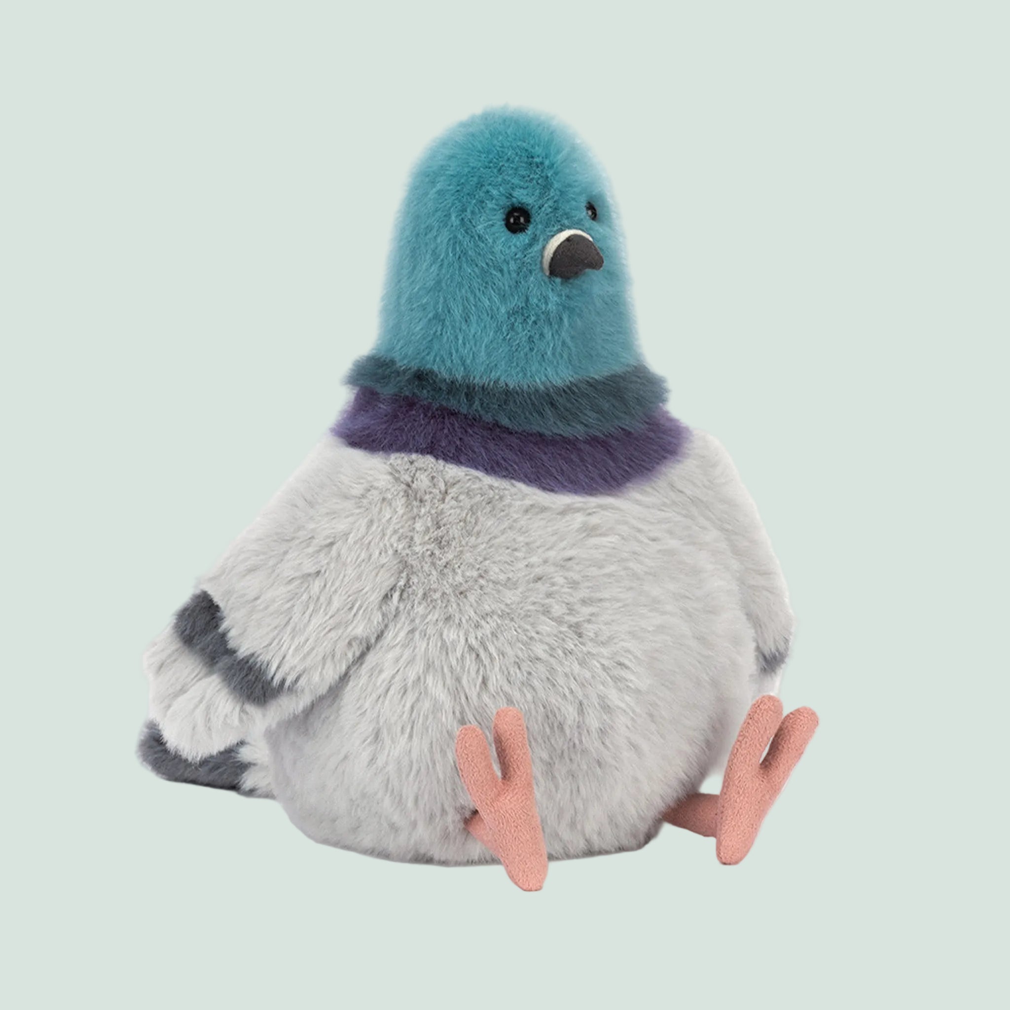 A blue and grey pigeon shaped stuffed animal toy. 