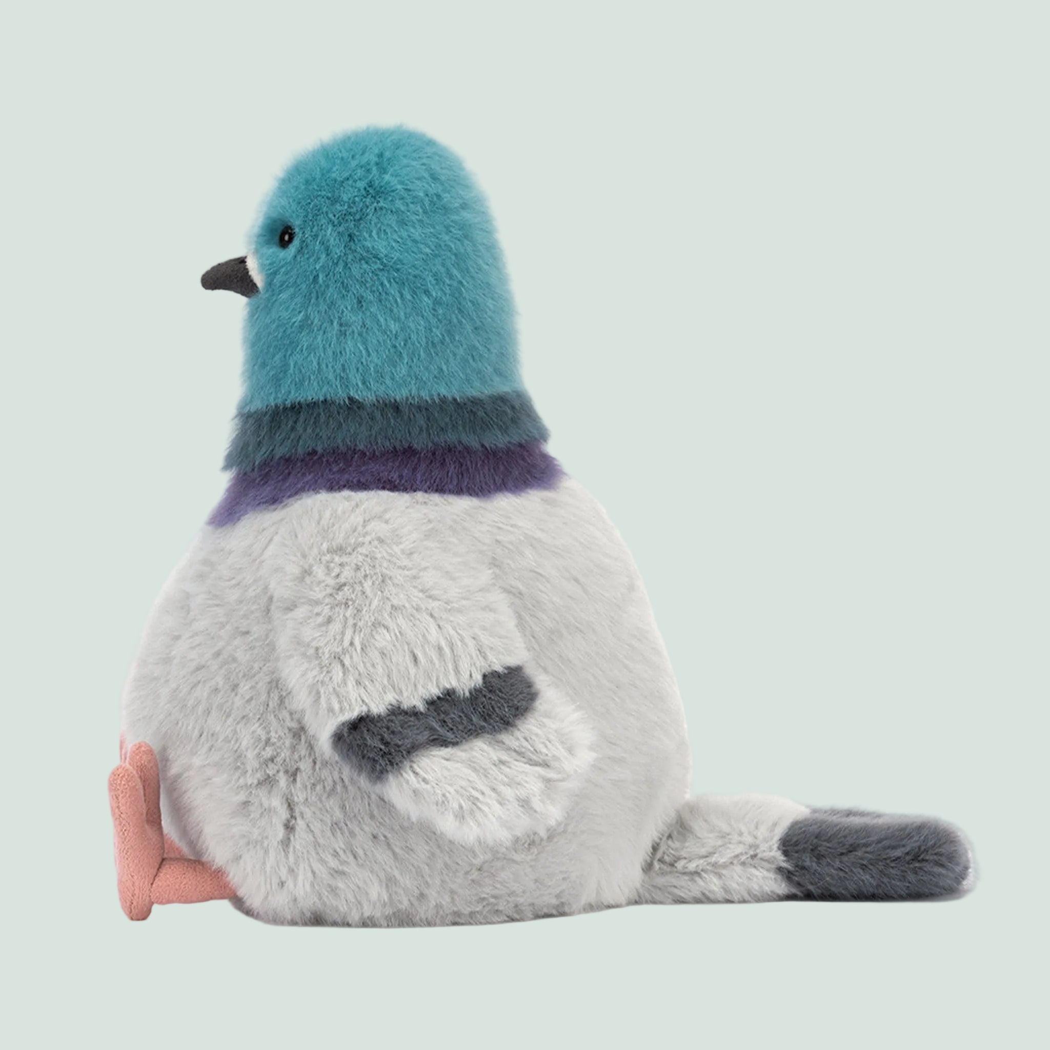 A blue and grey pigeon shaped stuffed animal toy. 