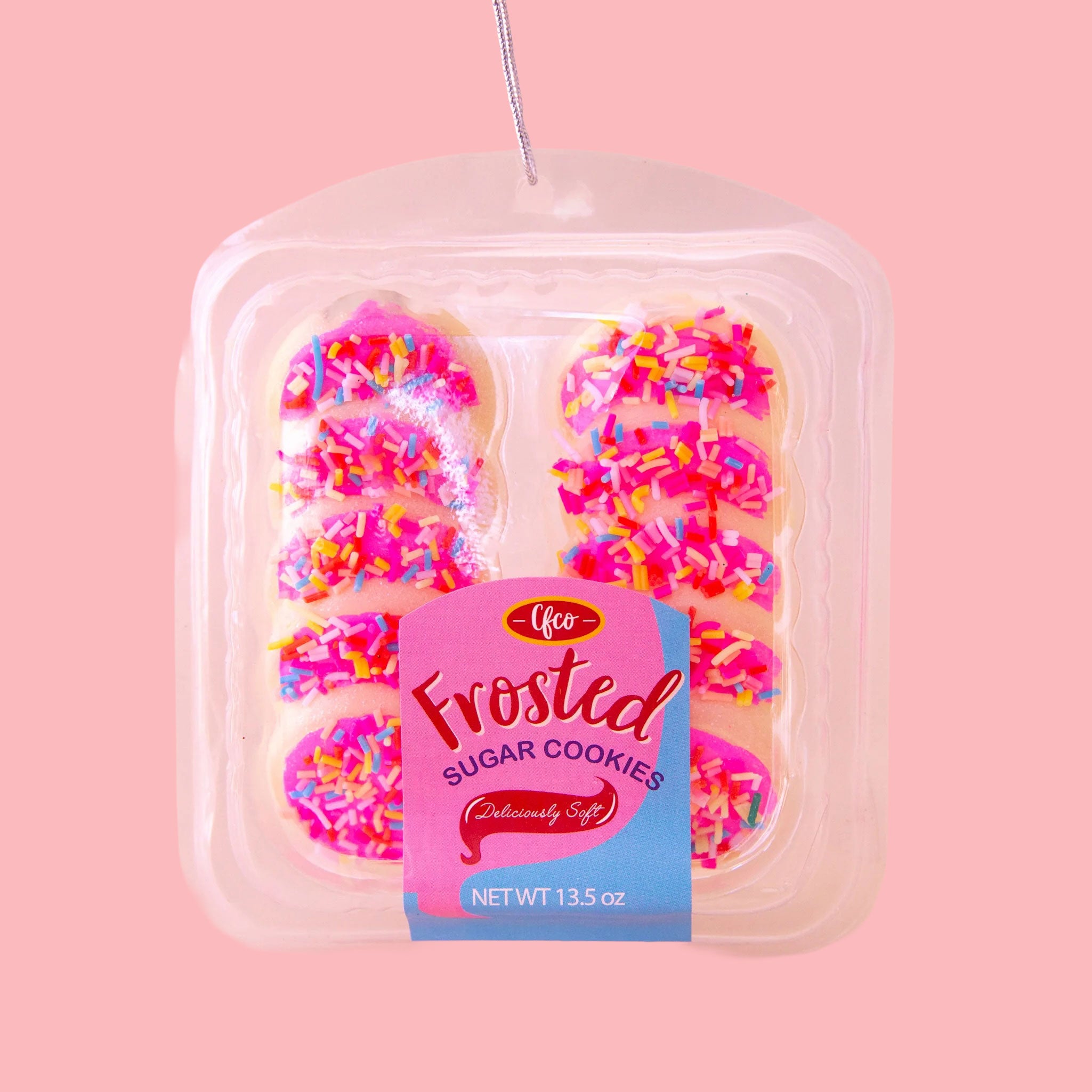 Pack of 10 pink frosted sugar cookies ornament. The cookies are settled in a plastic container and they have colorful sprinkles on the hot pink frosting. 