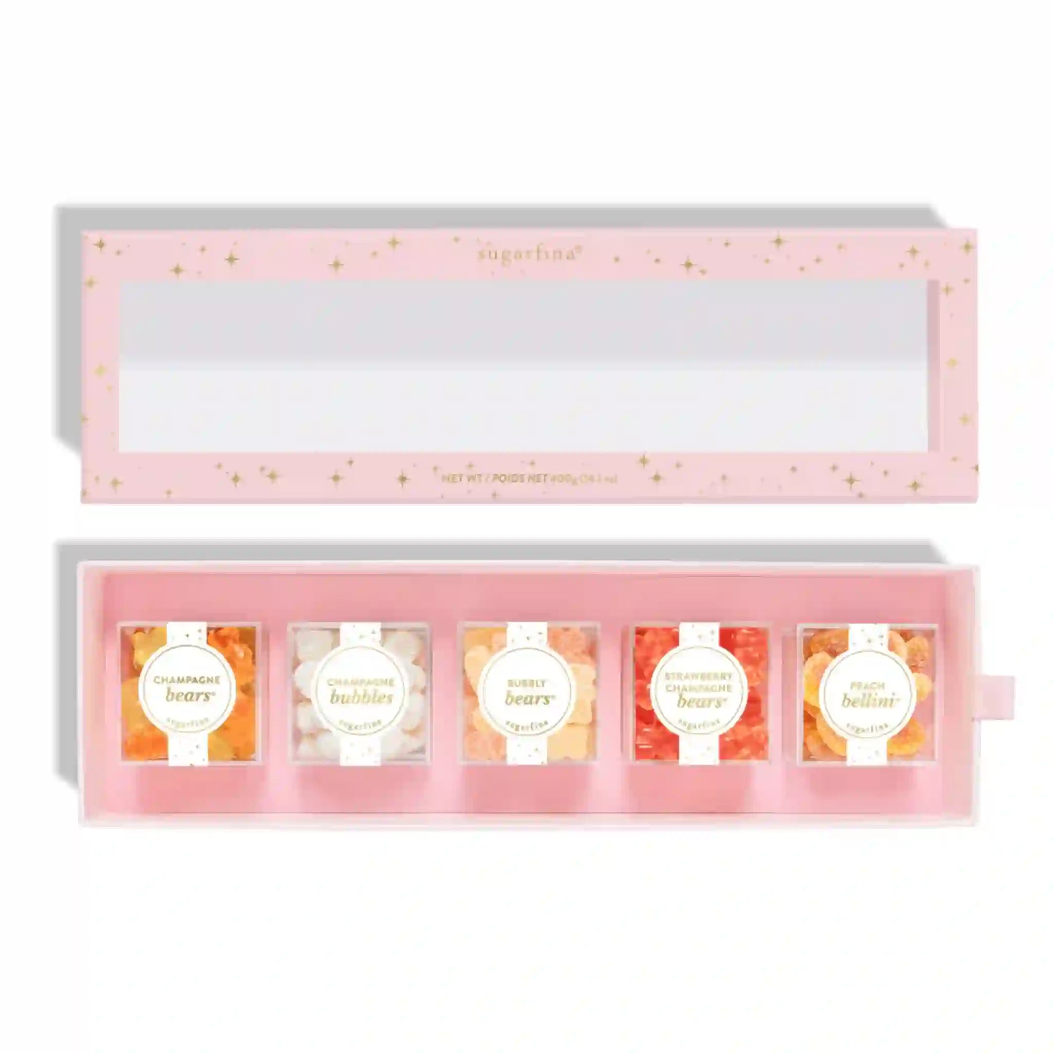 On a white background is a pink and gold star designed box filled with various Sugarfina candies. 