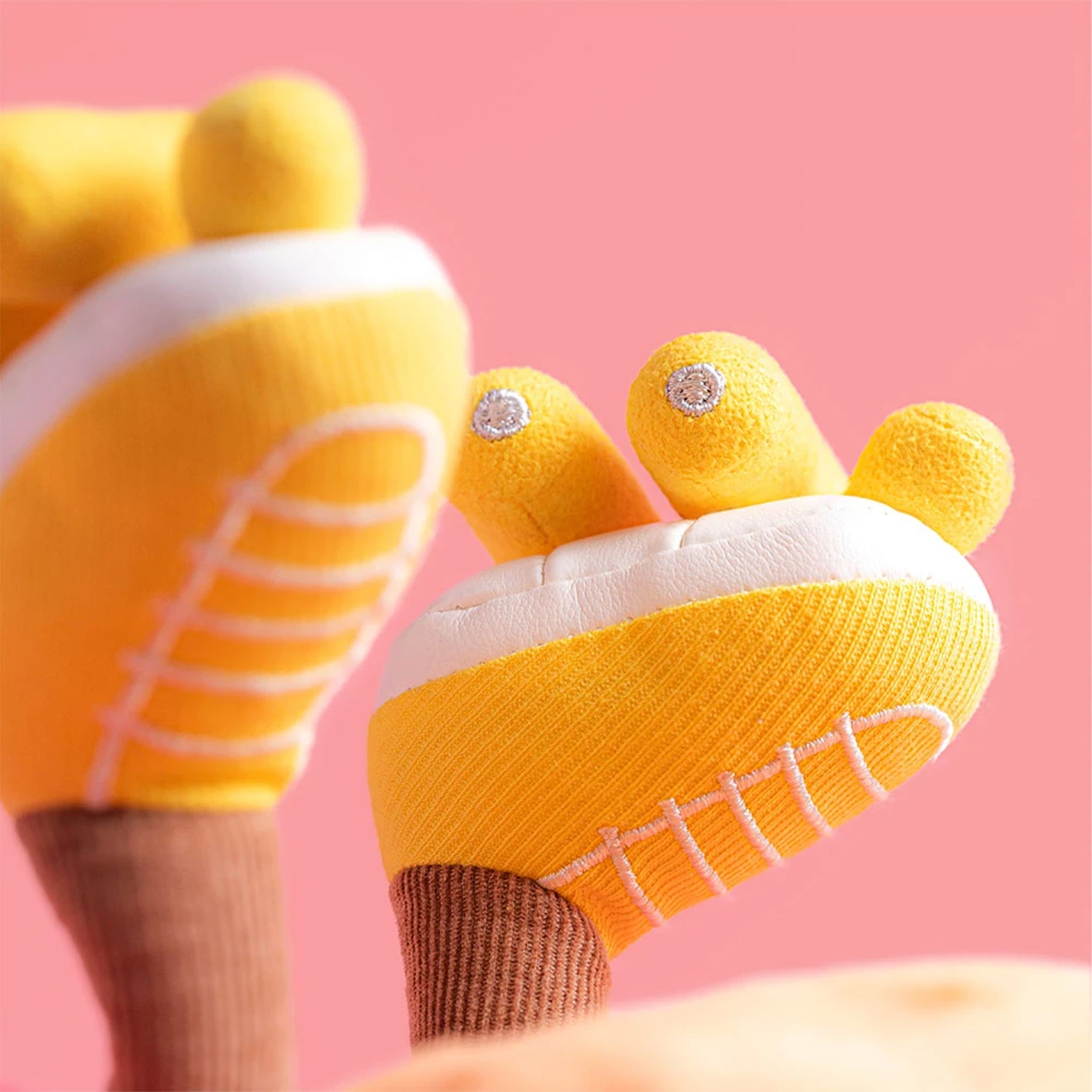 Plush toy with a sun-shaped body, pink and yellow accents 