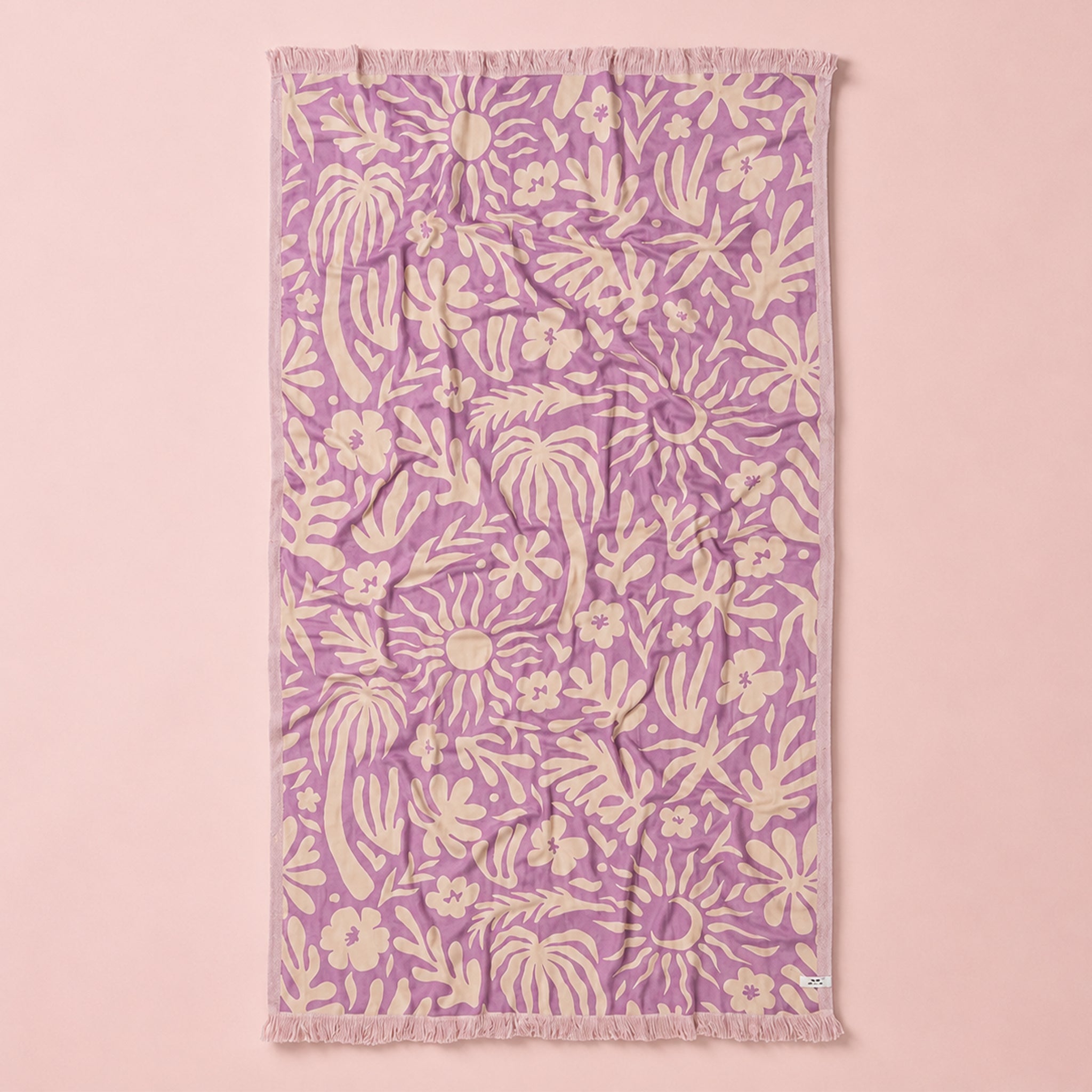 Floral patterned towel on a pink background