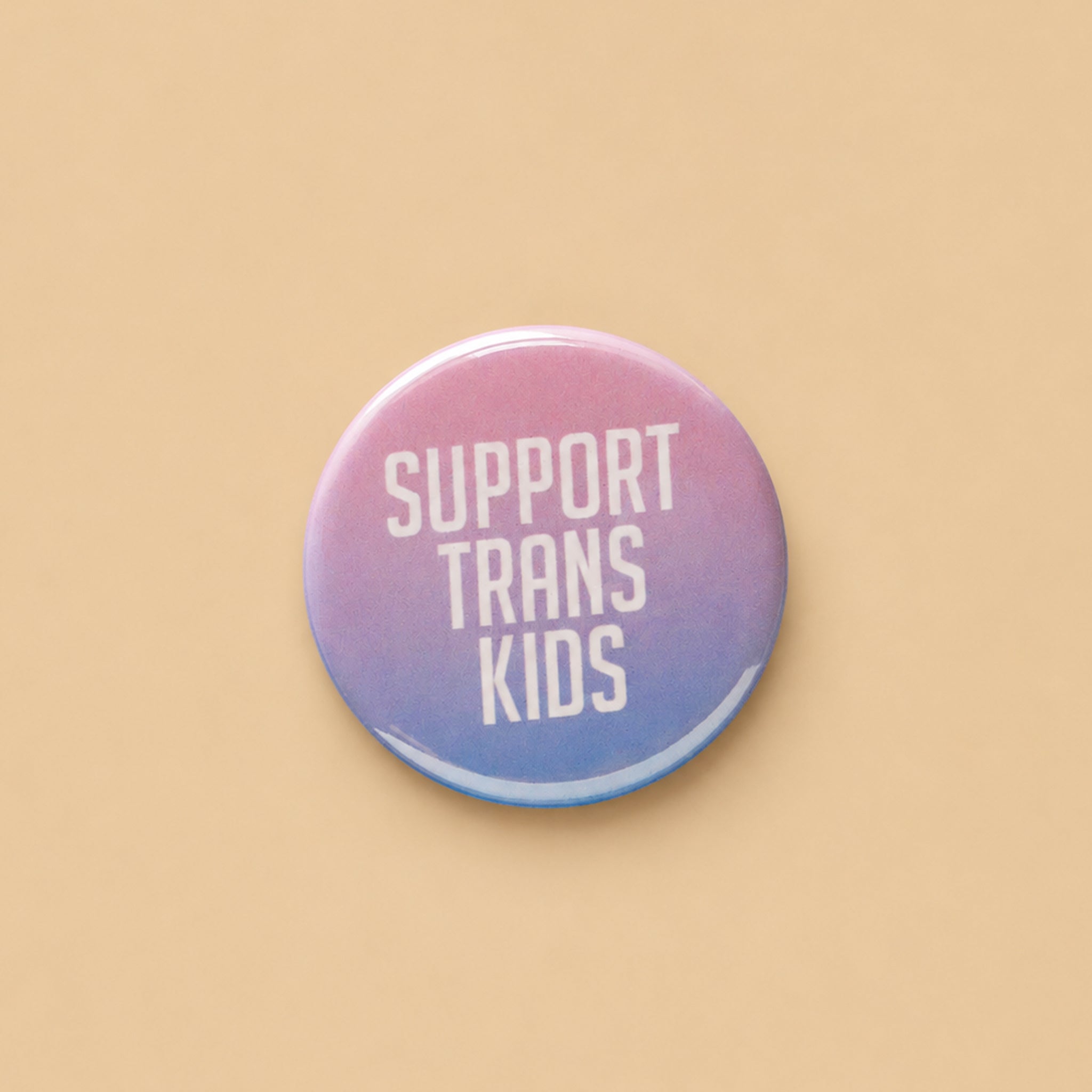 Small pink that reads 'Support Trans Kids' text on a gradient background