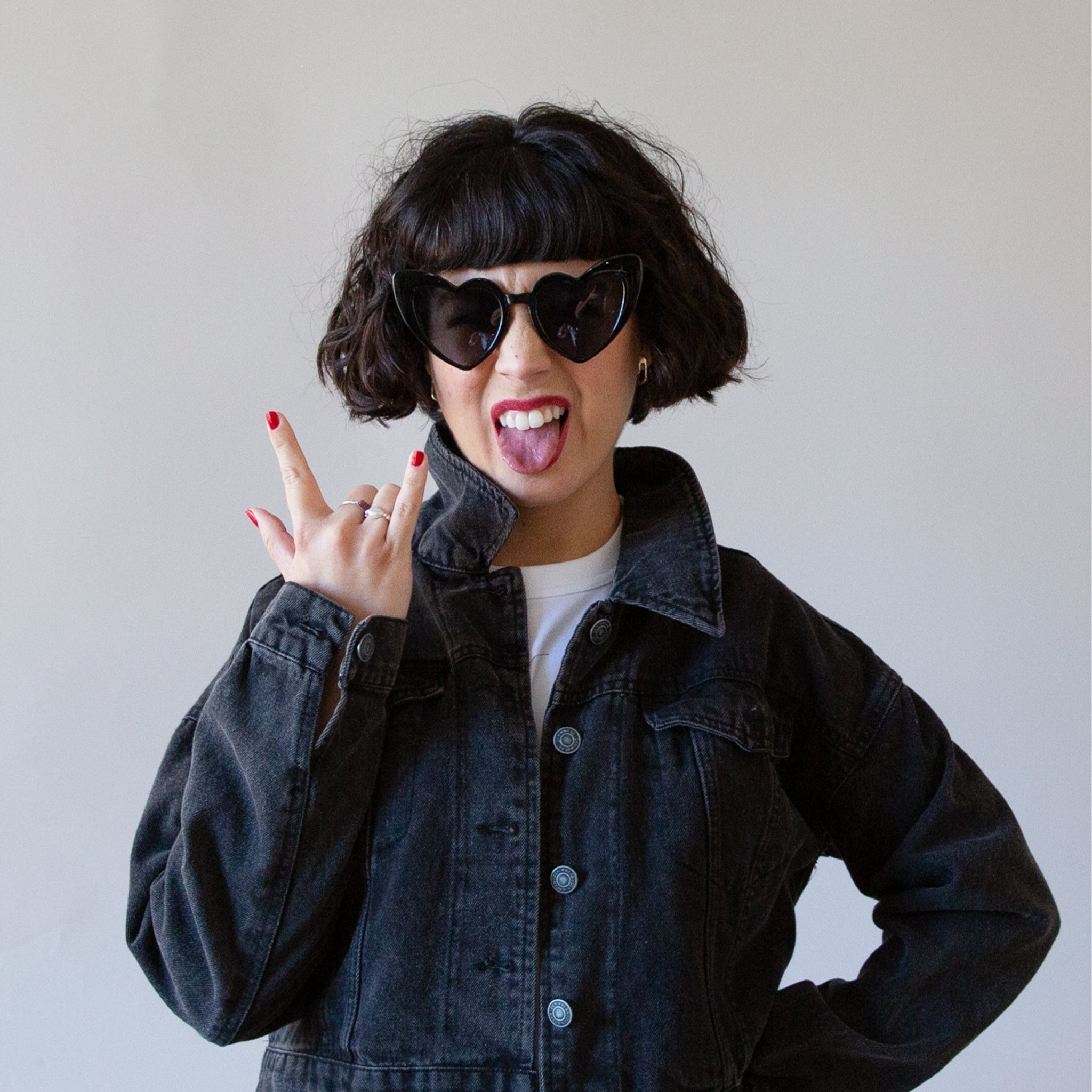 A black pair of heart shaped sunglasses. 