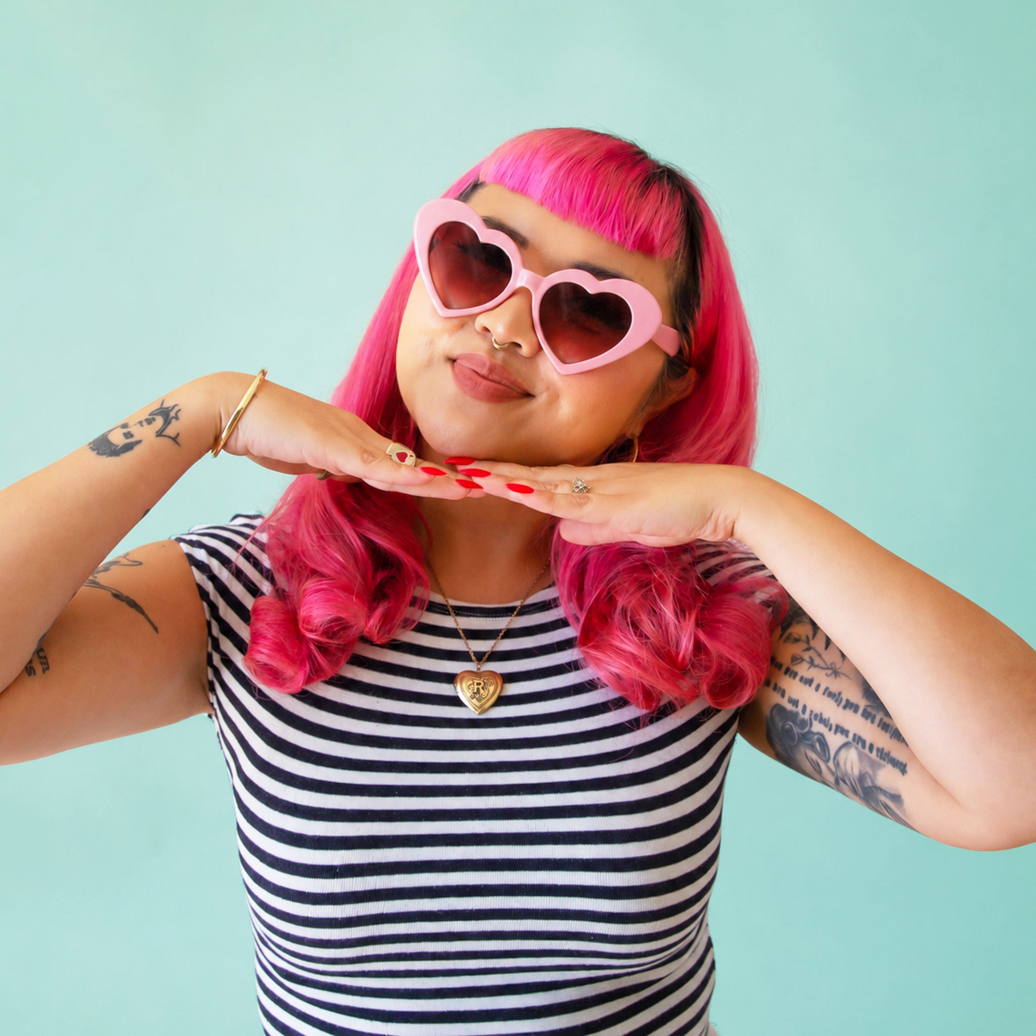 A pink pair of heart shaped sunglasses. 