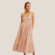 A light tannish pink dress with a strappy back and sweetheart neckline. 