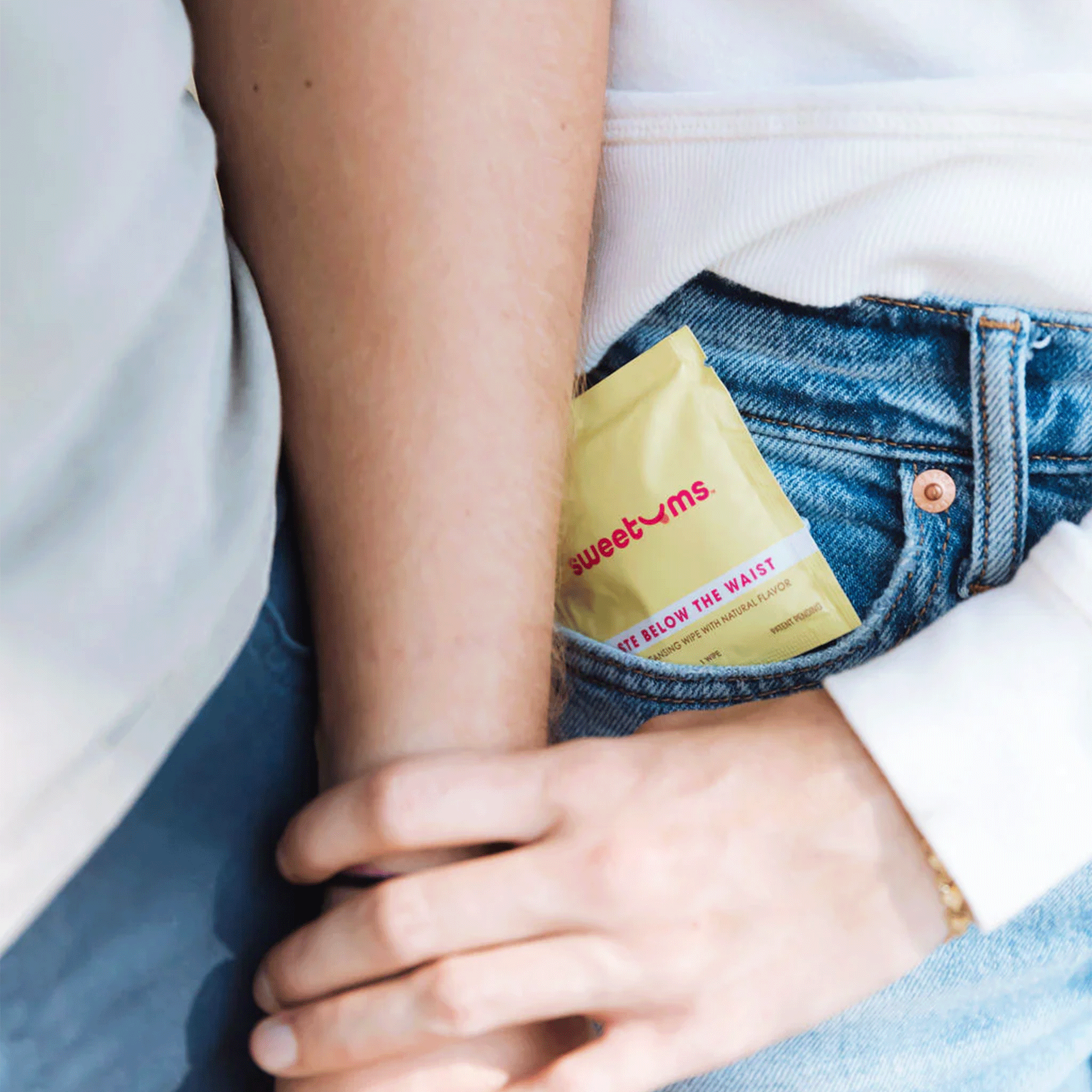 The yellow packet filled with the single use feminine wipe in a couple's pockets. 