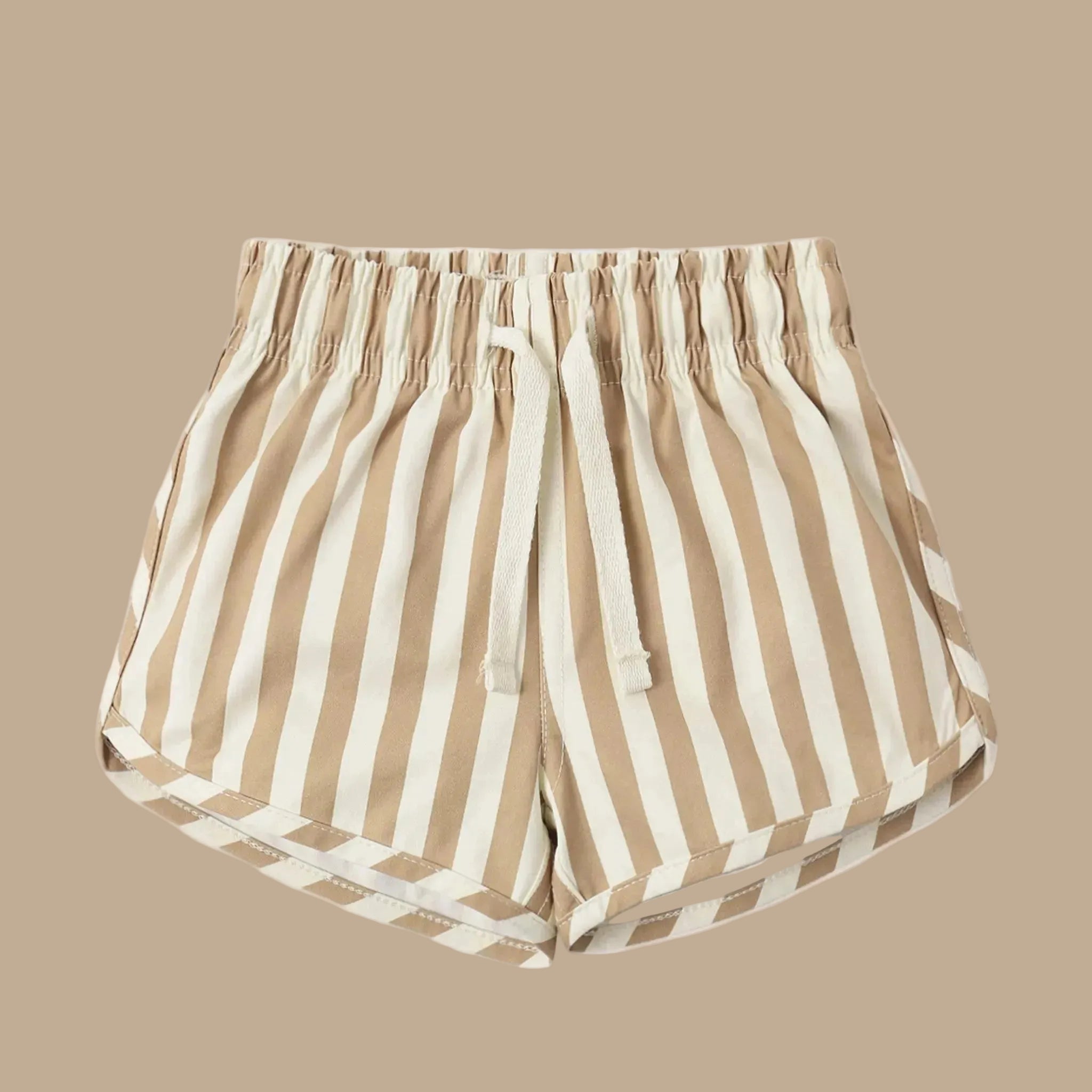 A tan and white striped pair of kids boardshorts. 