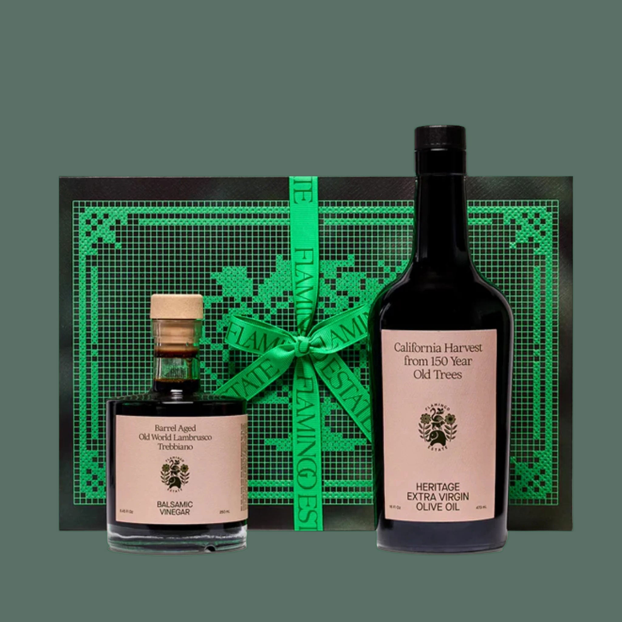 Two glass bottles of olive oil and balsamic with a mint green gift box. 
