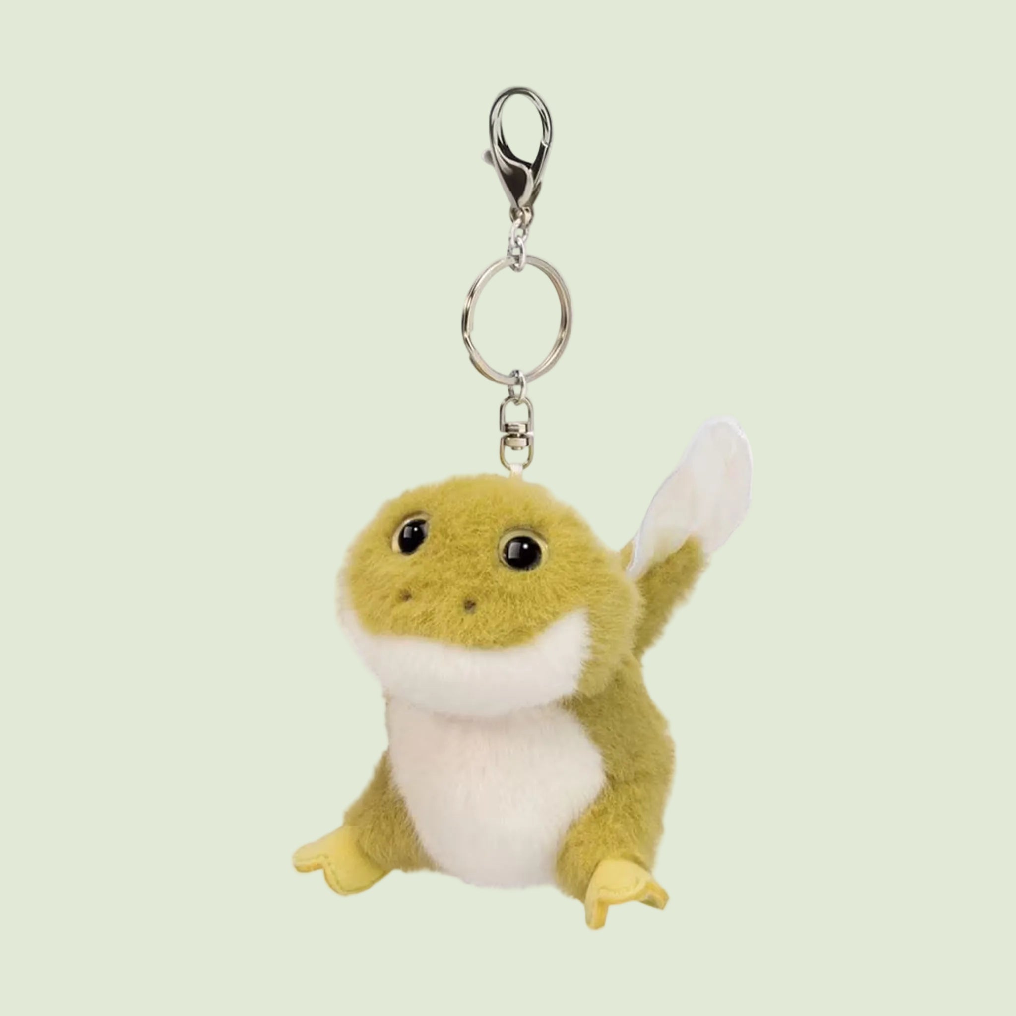 A green tadpole stuffed animal shaped keychain. 