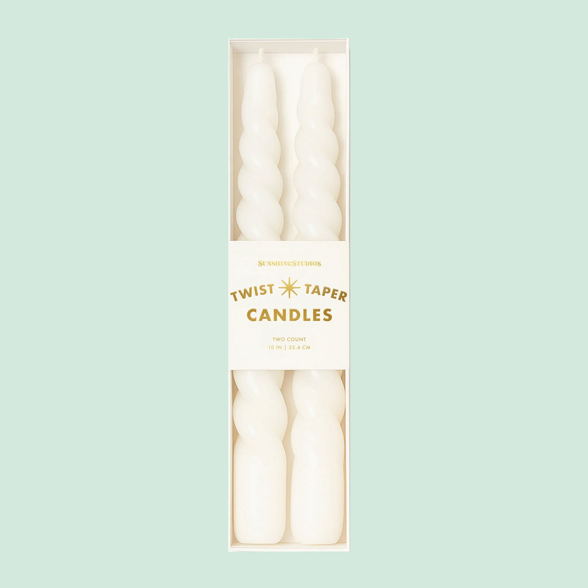 A pair of twisted white taper candles. 