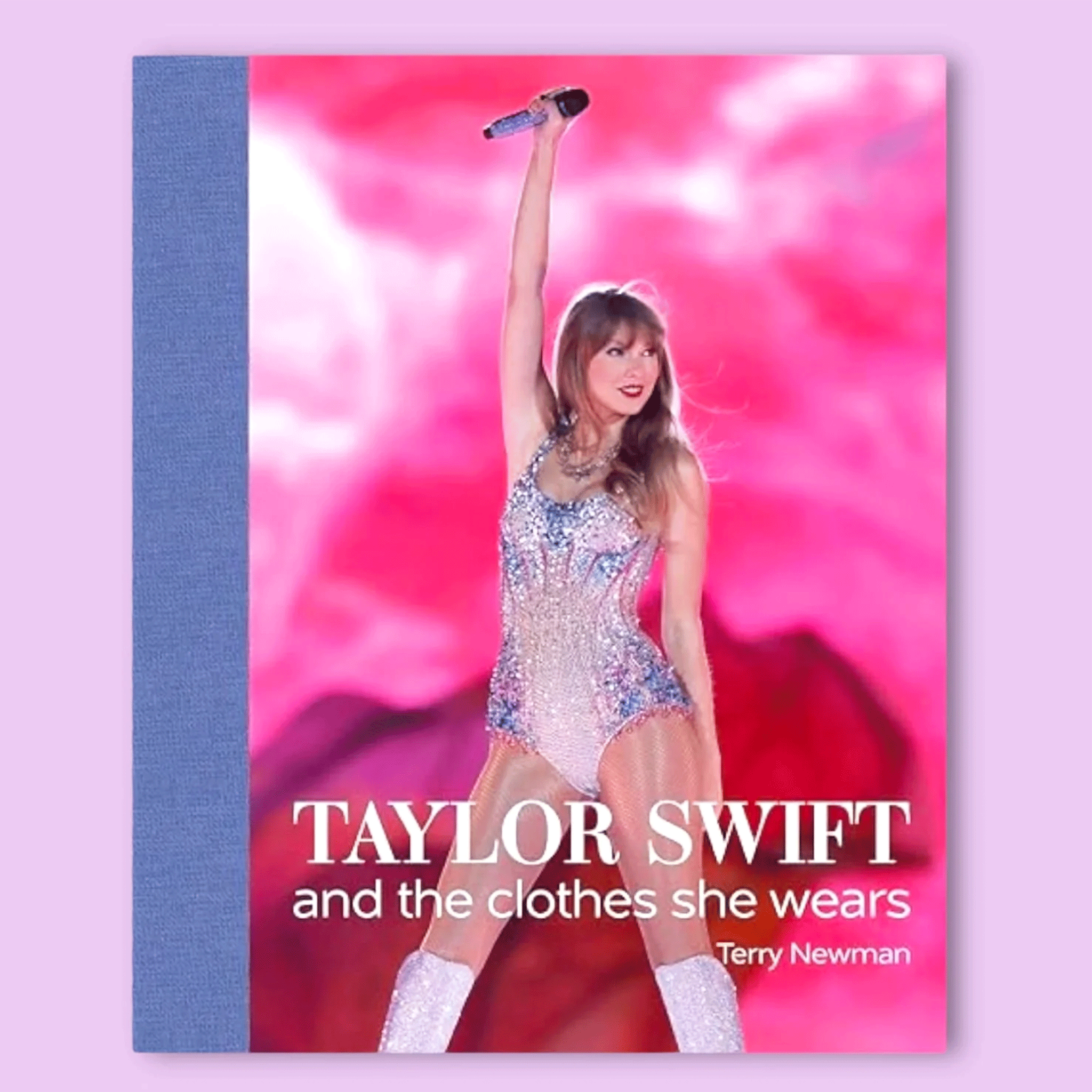 On a purple background is a hot pink book cover with a photo of Taylor Swift in her sparkle stage outfit along with text along the bottom half that reads, "Taylor Swift and the clothes she wears".  