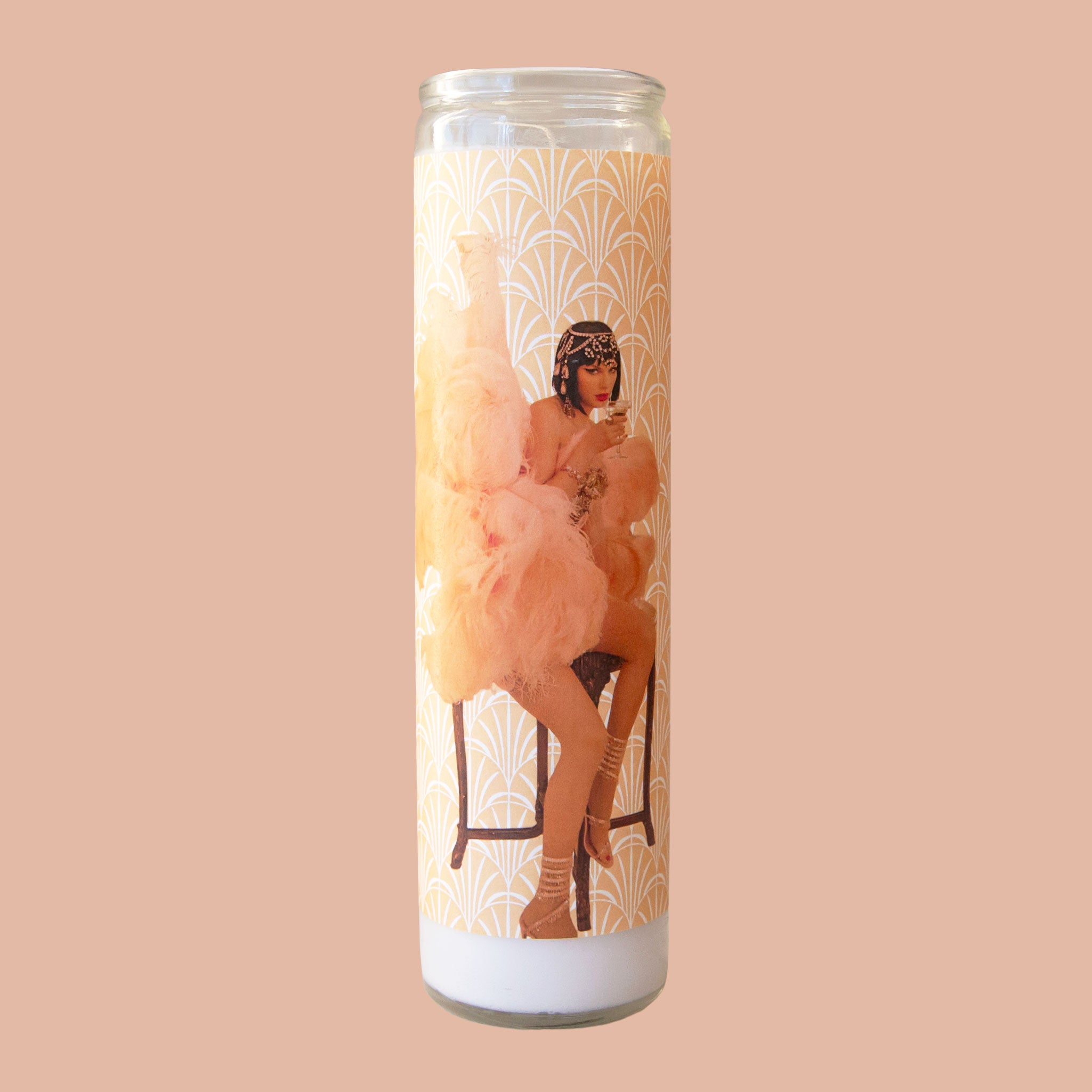 A prayer candle with a photo of Taylor Swift in her life of a showgirl outfit. 