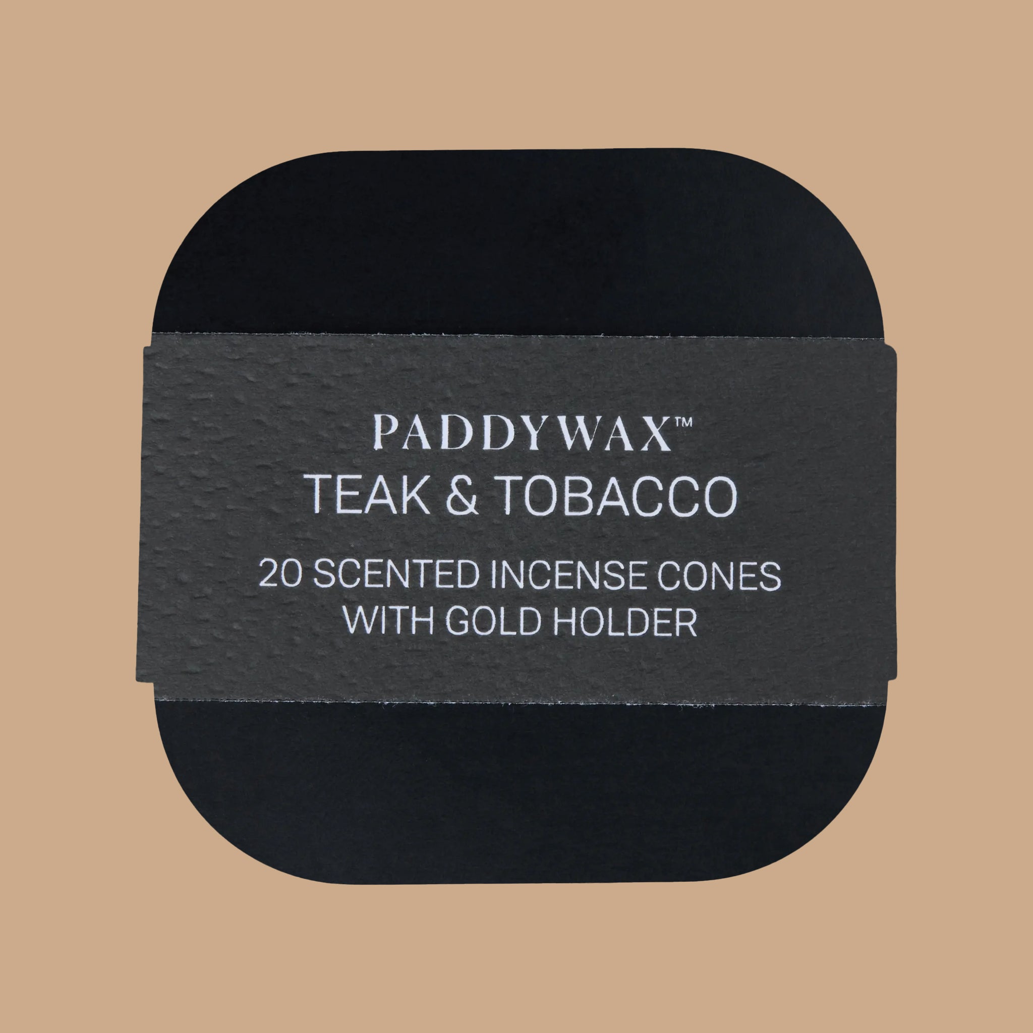 A black tin box filled with black cone incense and a gold small bowl. 