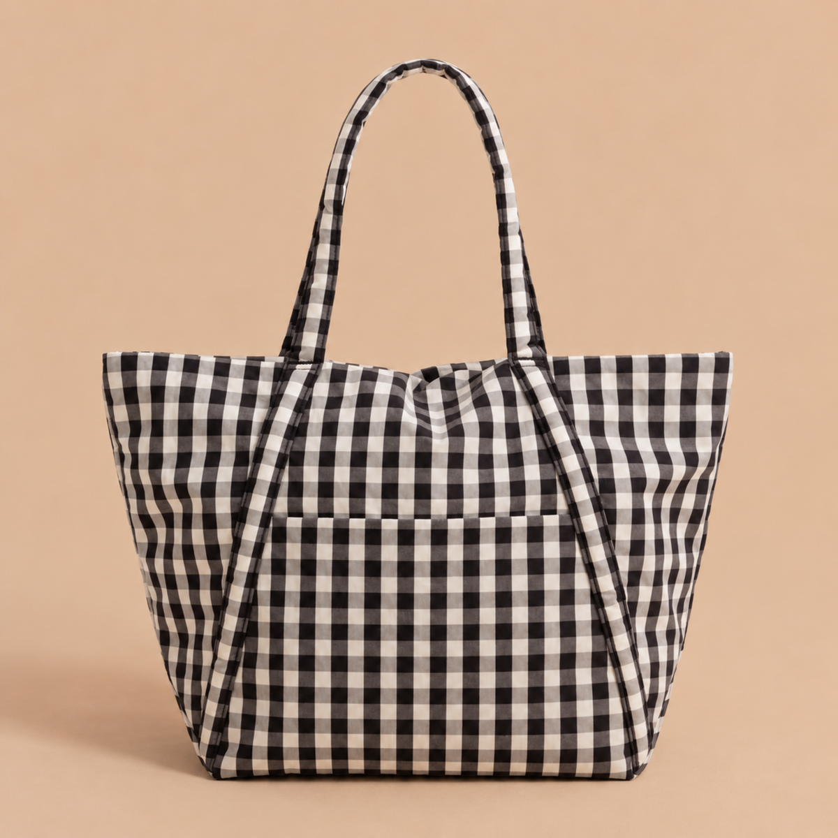 A black and white gingham tote bag with dual top handles, standing upright against a solid beige background.