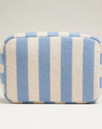 A terry blue and cream striped pouch with a gold zipper. 