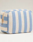A terry blue and cream striped pouch with a gold zipper. 