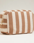 A white and tan striped terry pouch with a zipper closure. 