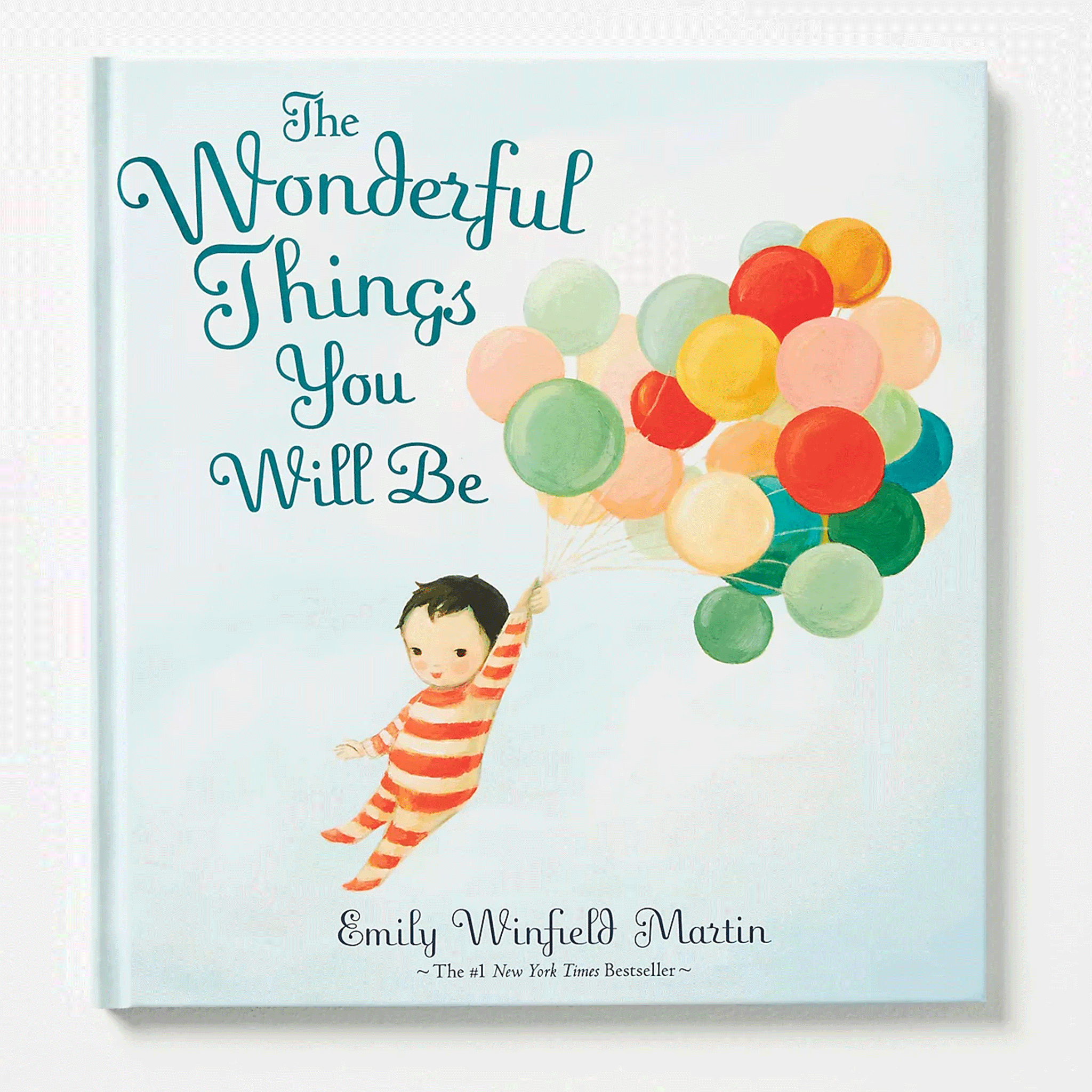 A young boy in red striped pajamas grips a bunch of colorful balloons, floating across the cover of the book. The title reads &#39;The Wonderful Things You Will Be&#39; in deep teal lettering.
