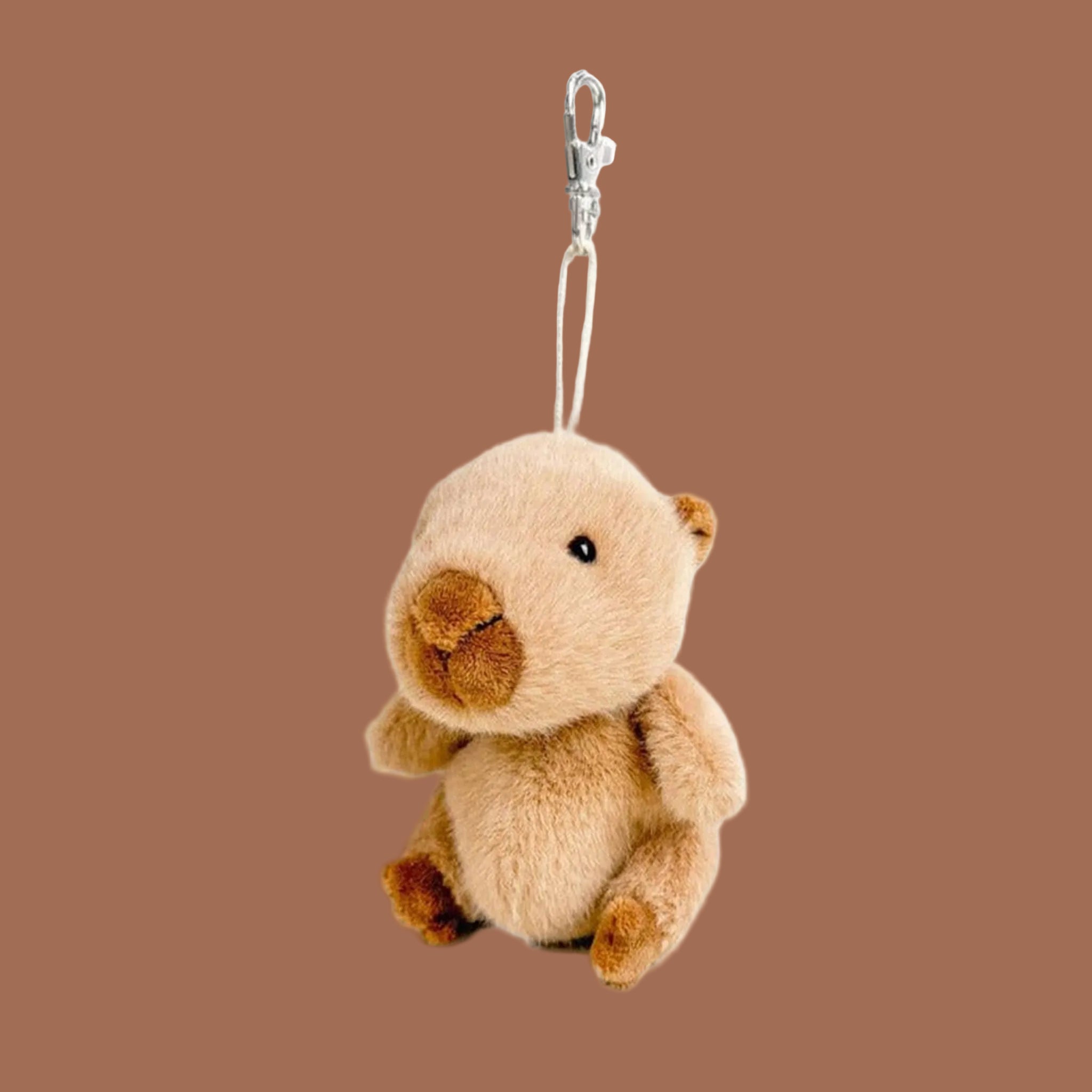 A capybara shaped small stuffed toy keychain. 