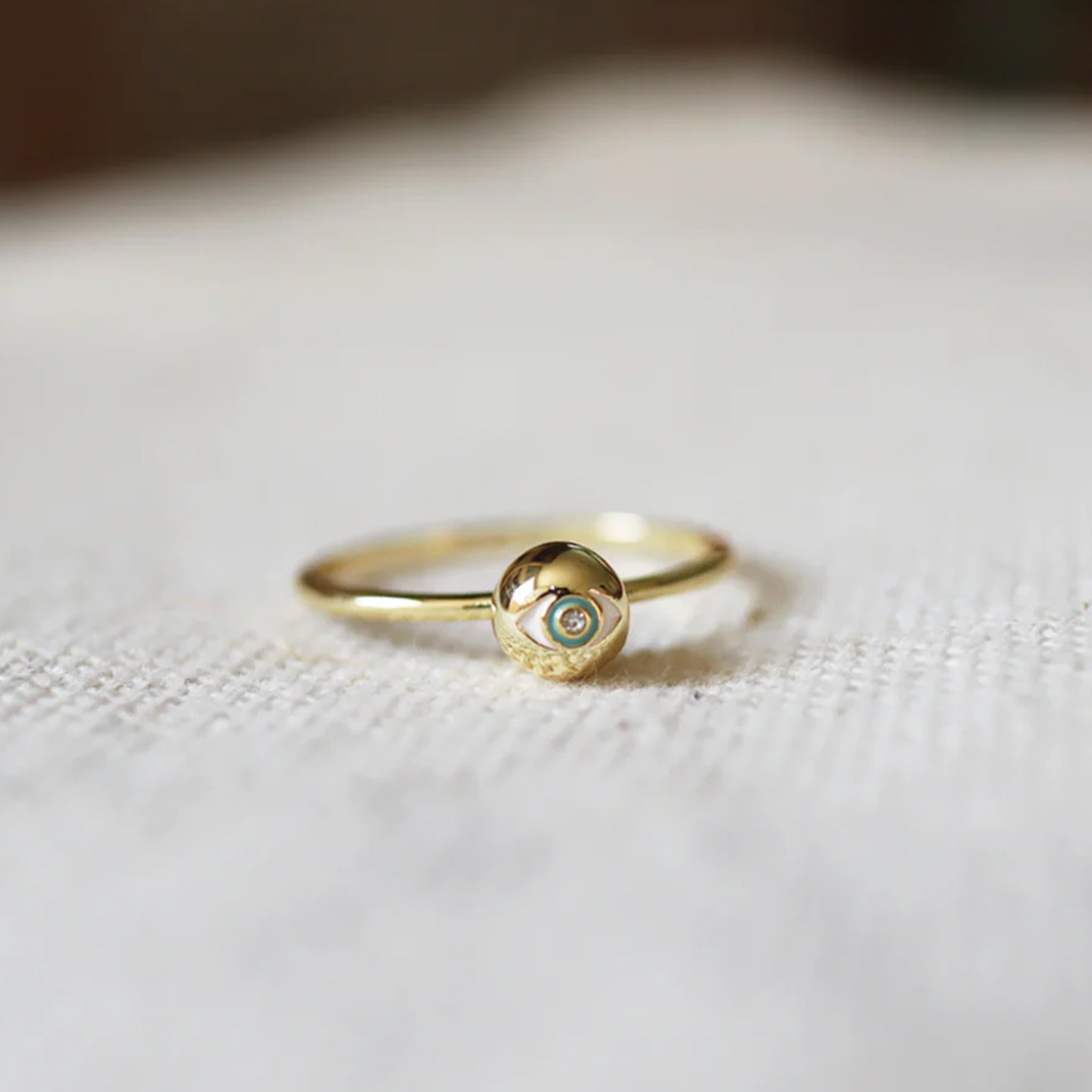 A gold ring with a circle eye shape in the center. 