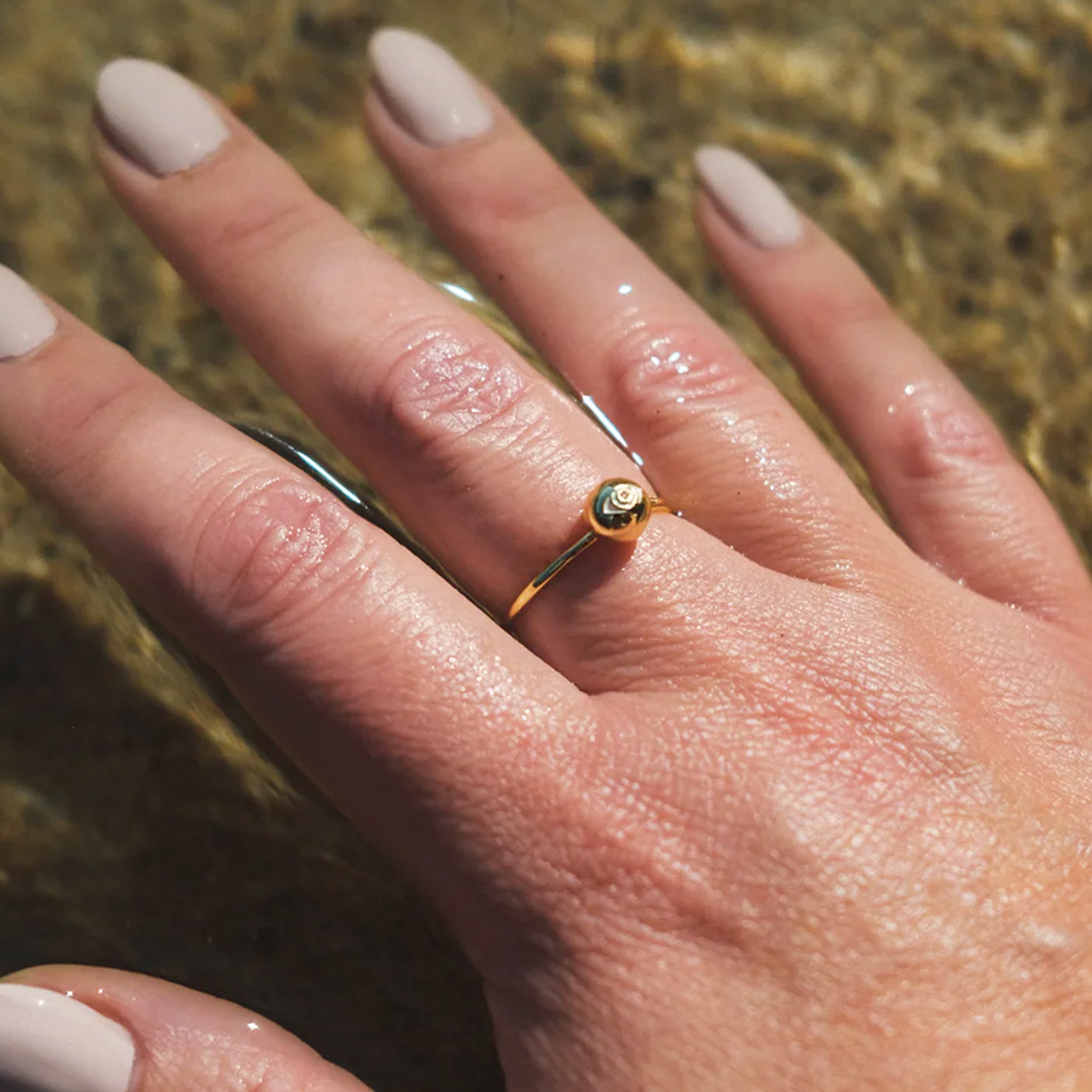 A gold ring with a circle eye shape in the center. 