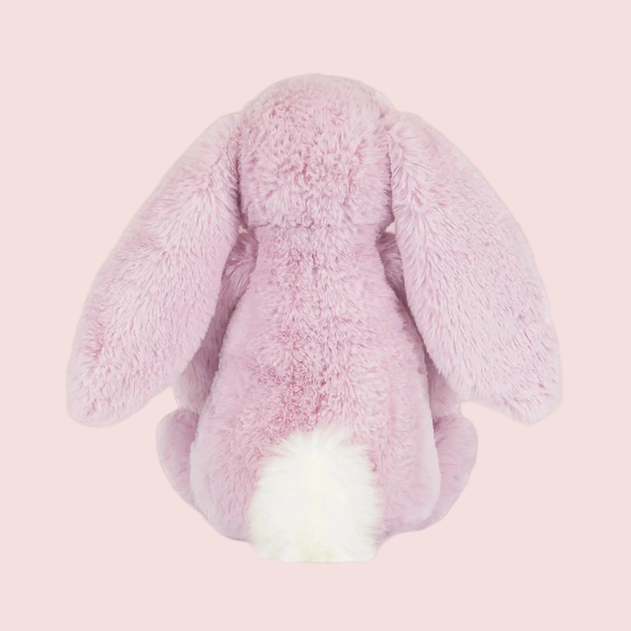A purple pink bunny shaped stuffed animal toy. 