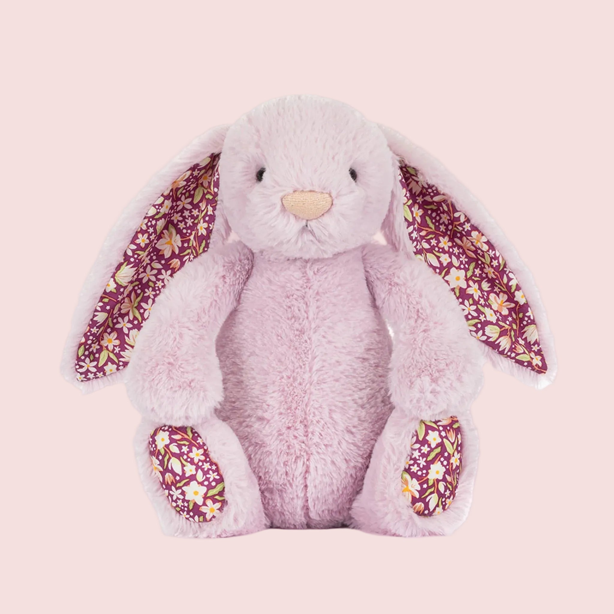 A purple pink bunny shaped stuffed animal toy. 