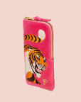 A hot pink velvet pouch with a tiger design and a zipper closure. 