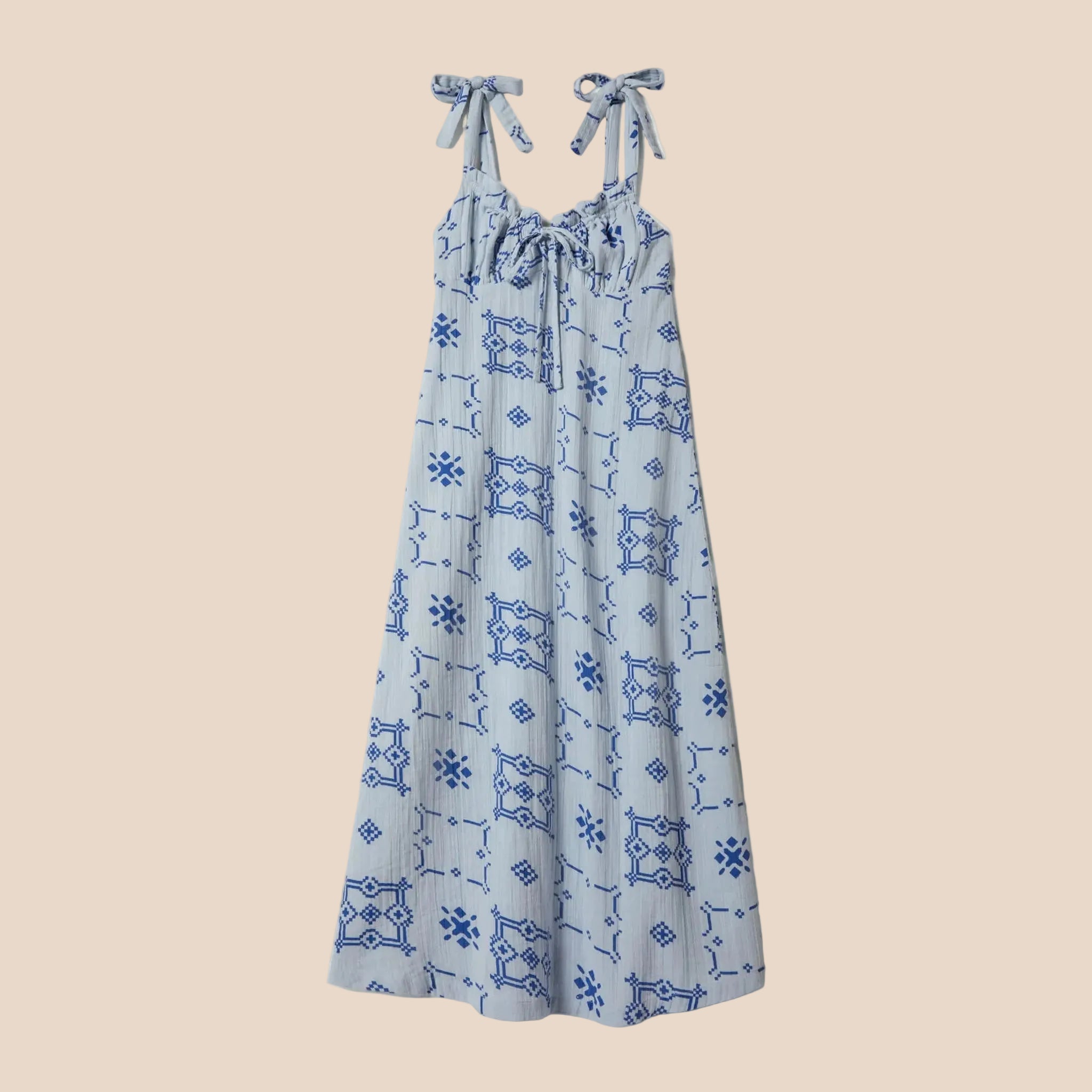A light blue dress with dark blue tile shaped graphics. 